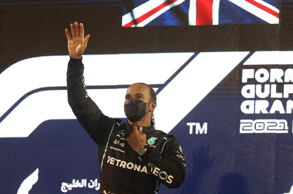 epa09103508 British Formula One driver Lewis Hamilton of Mercedes-AMG Petronas celebrates on the podium after winning the 2021 Formula One Grand Prix of Bahrain at the Sakhir circuit near Manama, Bahrain, 28 March 2021.  EPA-EFE/Lars Baron / POOL