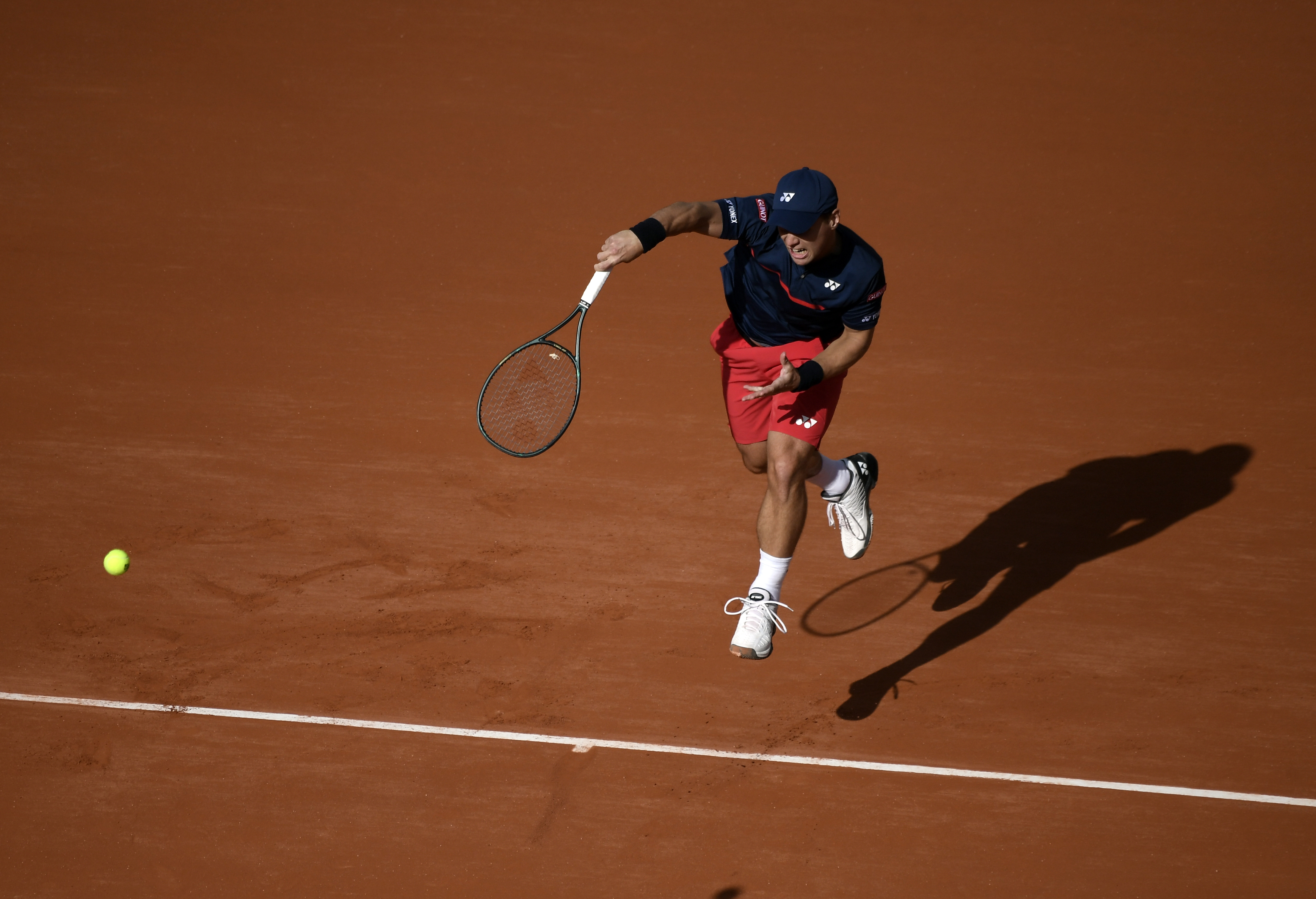 epa08712459 Ricardas Berankis of Lithuania in action against Novak Djokovic of Serbia during their men?s second round match during the French Open tennis tournament at Roland ?Garros in Paris, France, 01 October 2020.  EPA-EFE/JULIEN DE ROSA