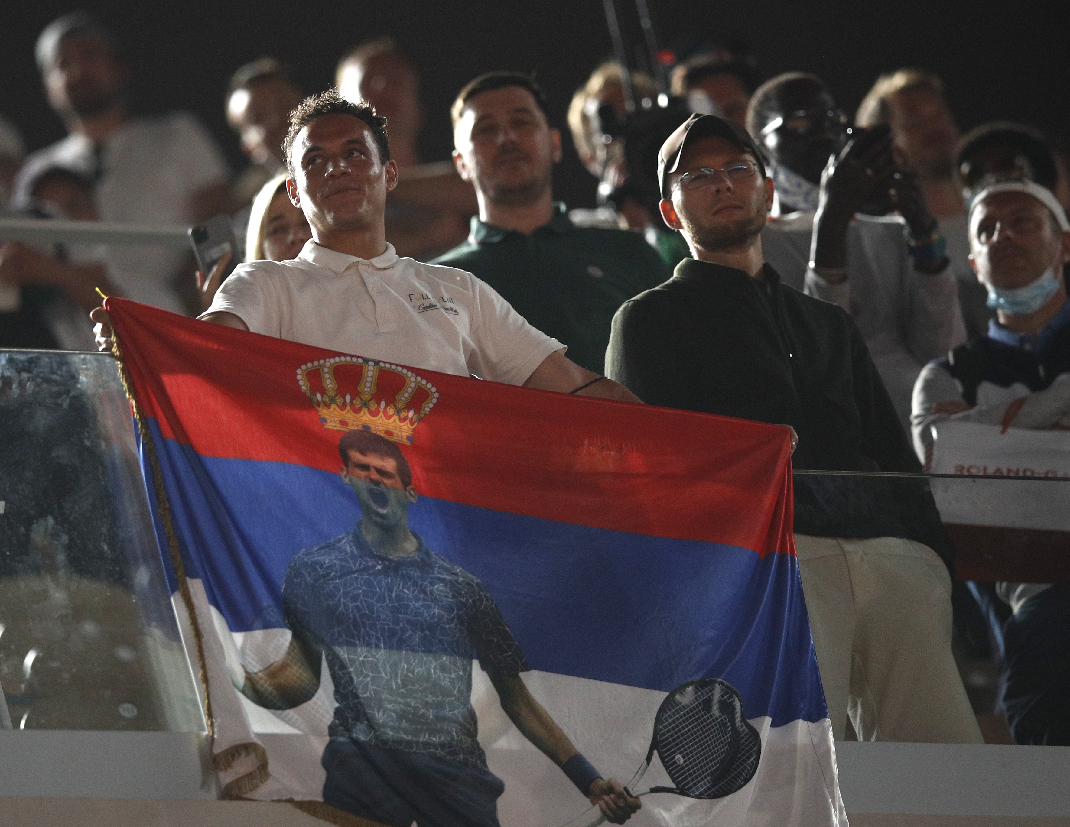 epa09263582 Supporters of Novak Djokovic of Serbia celebrate after his win against Rafael Nadal of Spain during their semi final match at the French Open tennis tournament at Roland Garros in Paris, France, 11 June 2021.  EPA-EFE/YOAN VALAT