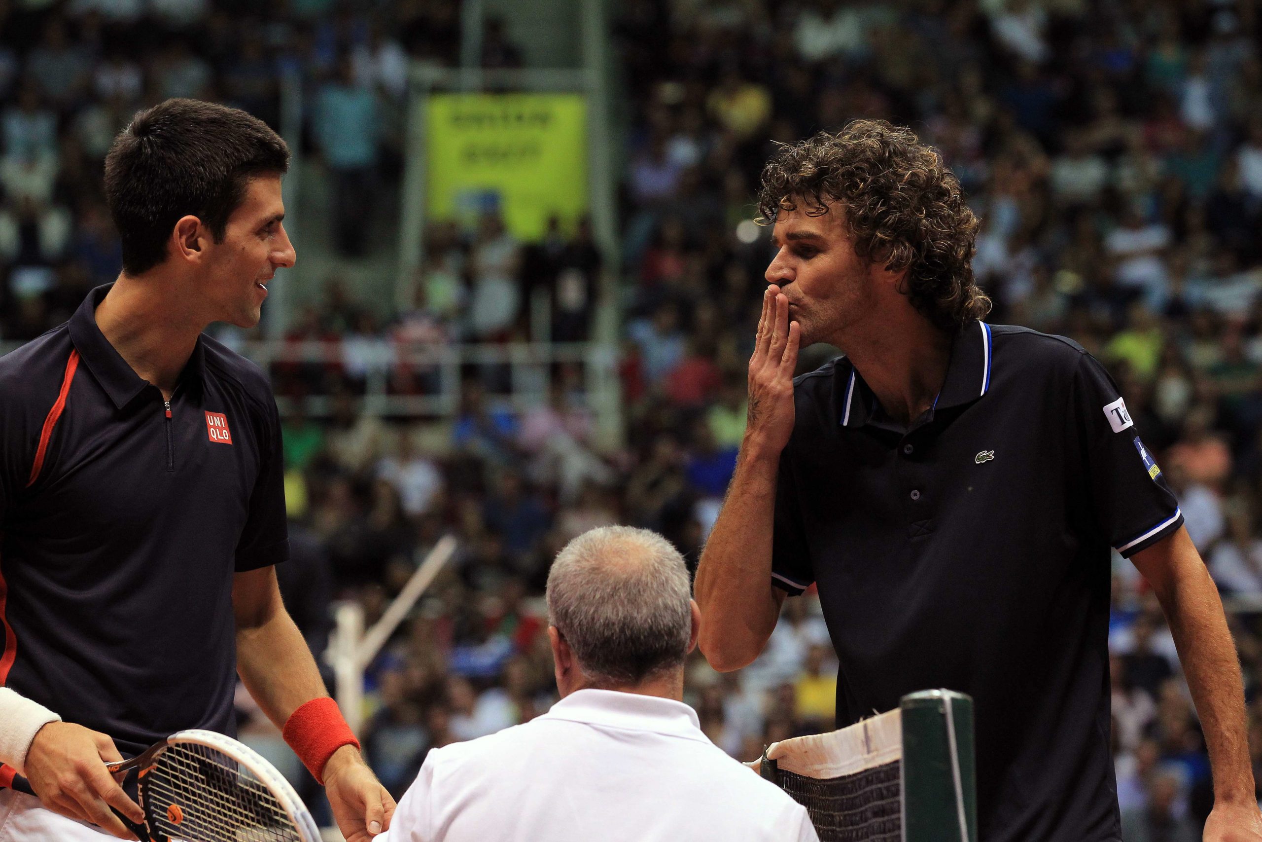 epa03475792 Brazilian former tennis player Gustavo Kuerten (R) sends a kiss to Serbian Novak Djokovic as a joke during an exhibition game at Maracanazinho colliseum in Rio de Janeiro, Brazil, 17 November 2012.  EPA/Marcelo Sayao