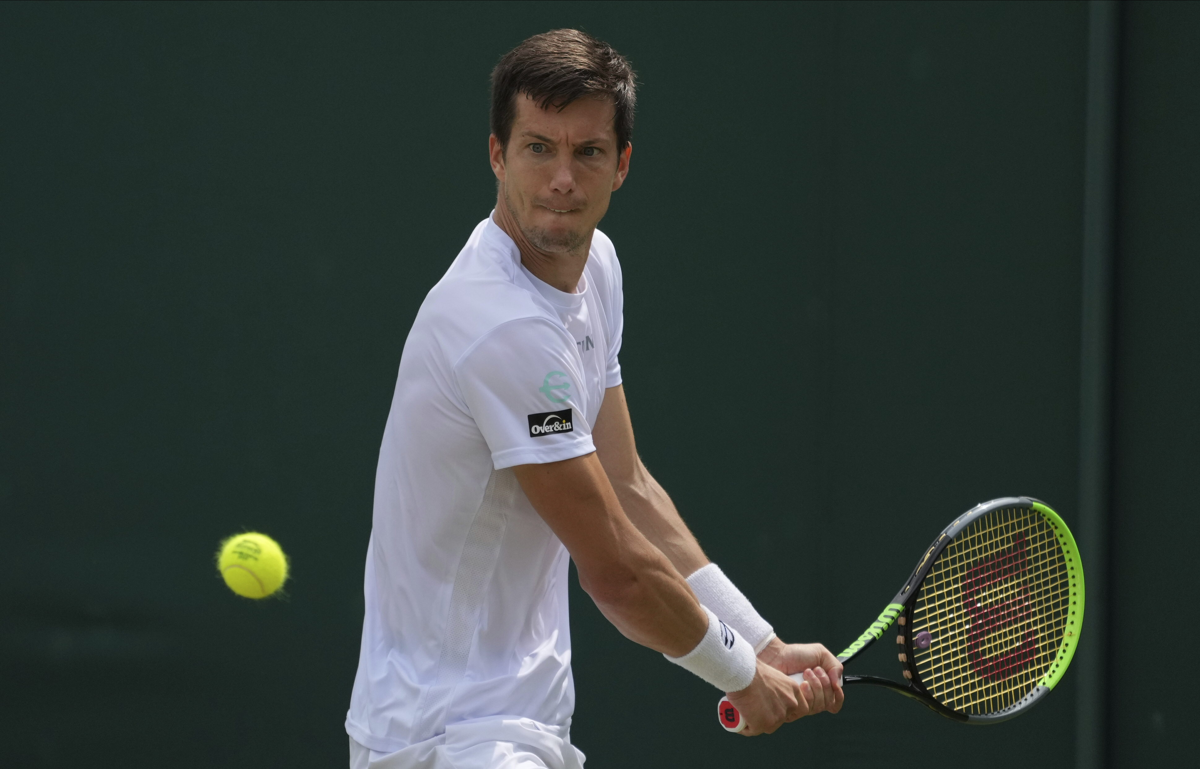 Slovenia's Aljaz Bedene plays a return to Japan's Yoshihito Nishioka during the men's singles second round match on day four of the Wimbledon Tennis Championships in London, Thursday July 1, 2021. (AP Photo/Alberto Pezzali)