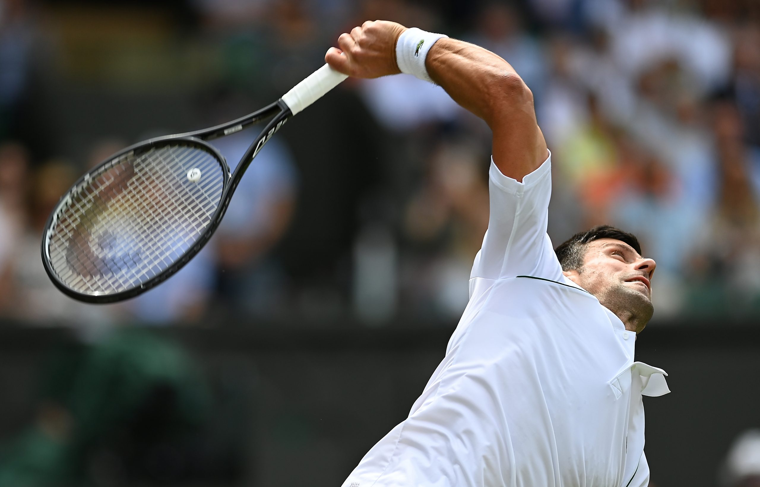 epa09323723 Novak Djokovic of Serbia in action during his round of 16 match against Cristian Garin of Chile at the Wimbledon Championships, Wimbledon, Britain 05 July 2021.  EPA-EFE/NEIL HALL   EDITORIAL USE ONLY  EDITORIAL USE ONLY