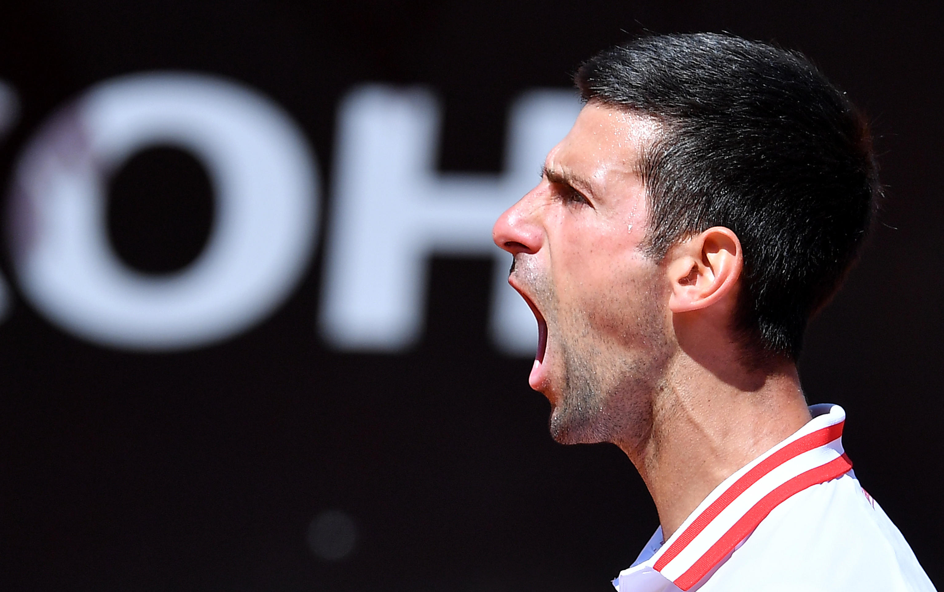 epa09201108 Novak Djokovic of Serbia reacts during his men's singles quarterfinal match against Stefanos Tsitsipas of Greece at the Italian Open tennis tournament in Rome, Italy, 15 May 2021.  EPA-EFE/ETTORE FERRARI