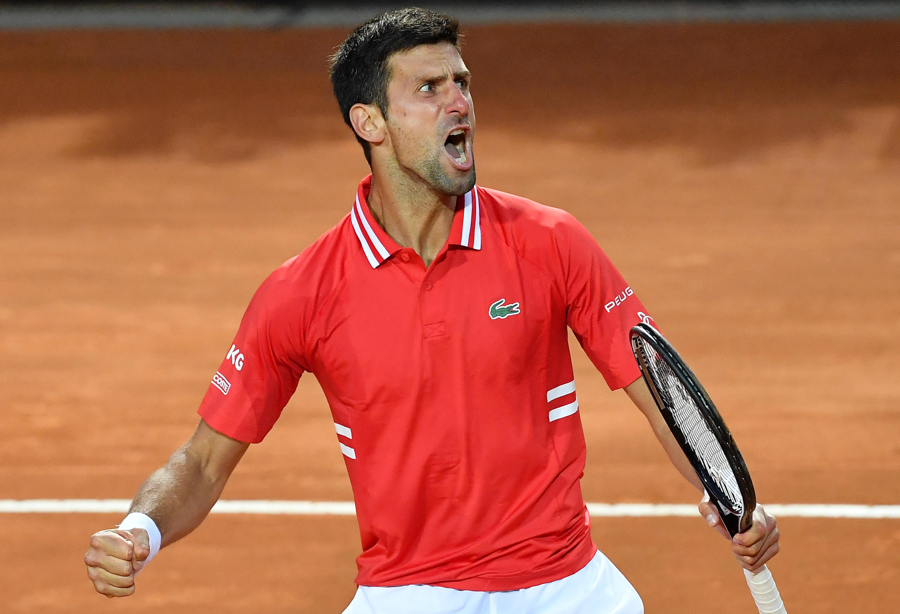 epa09202822 Novak Djokovic of Serbia reacts during his men's singles semi final match against Lorenzo Sonego of Italy at the Italian Open tennis tournament in Rome, Italy, 15 May 2021.  EPA-EFE/ETTORE FERRARI