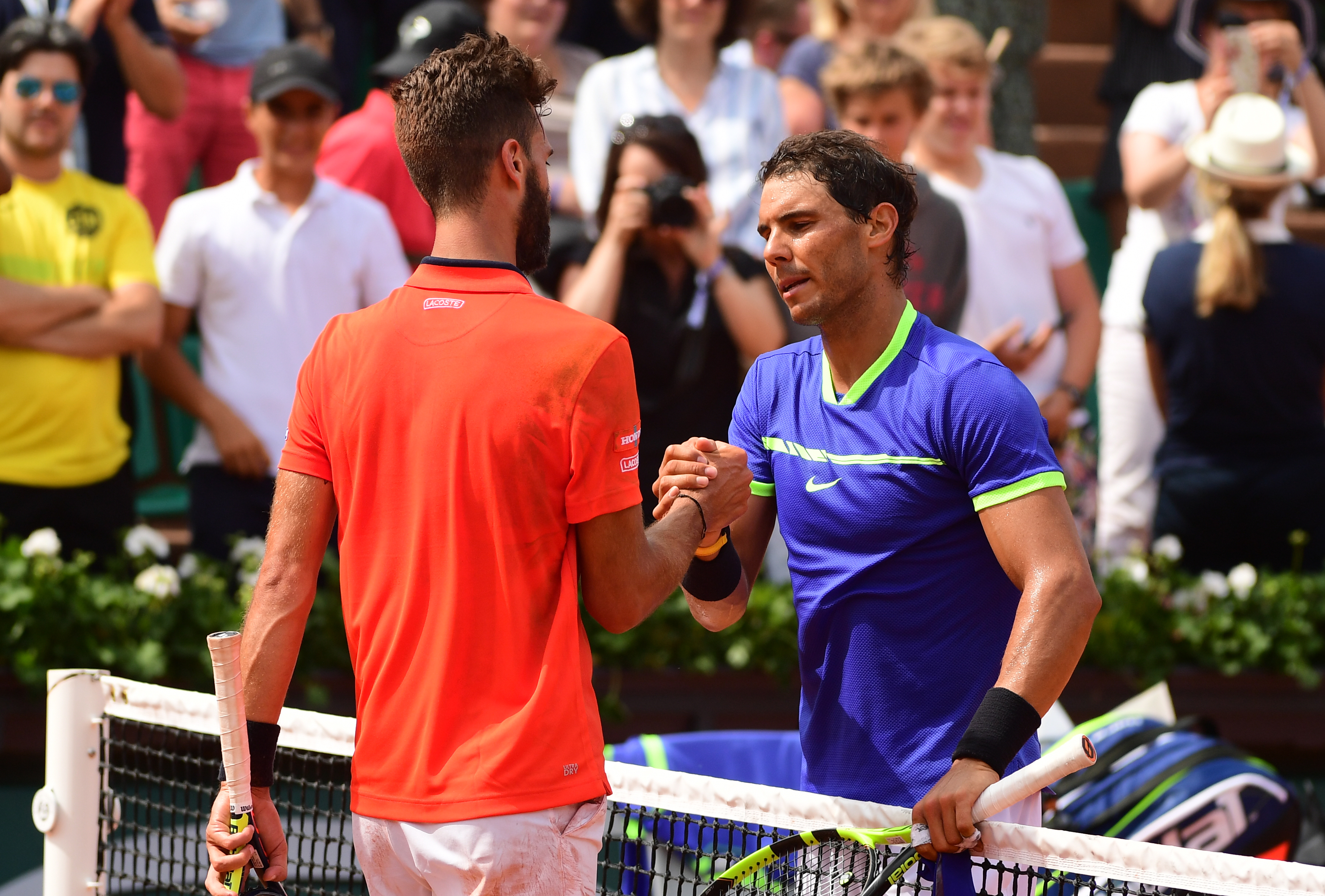 epa05997603 Rafael Nadal of Spain reacts with Benoit Paire of France after winning their men?s 1st round single match  during the French Open tennis tournament at Roland Garros in Paris, France, 29 May 2017.  EPA/CAROLINE BLUMBERG