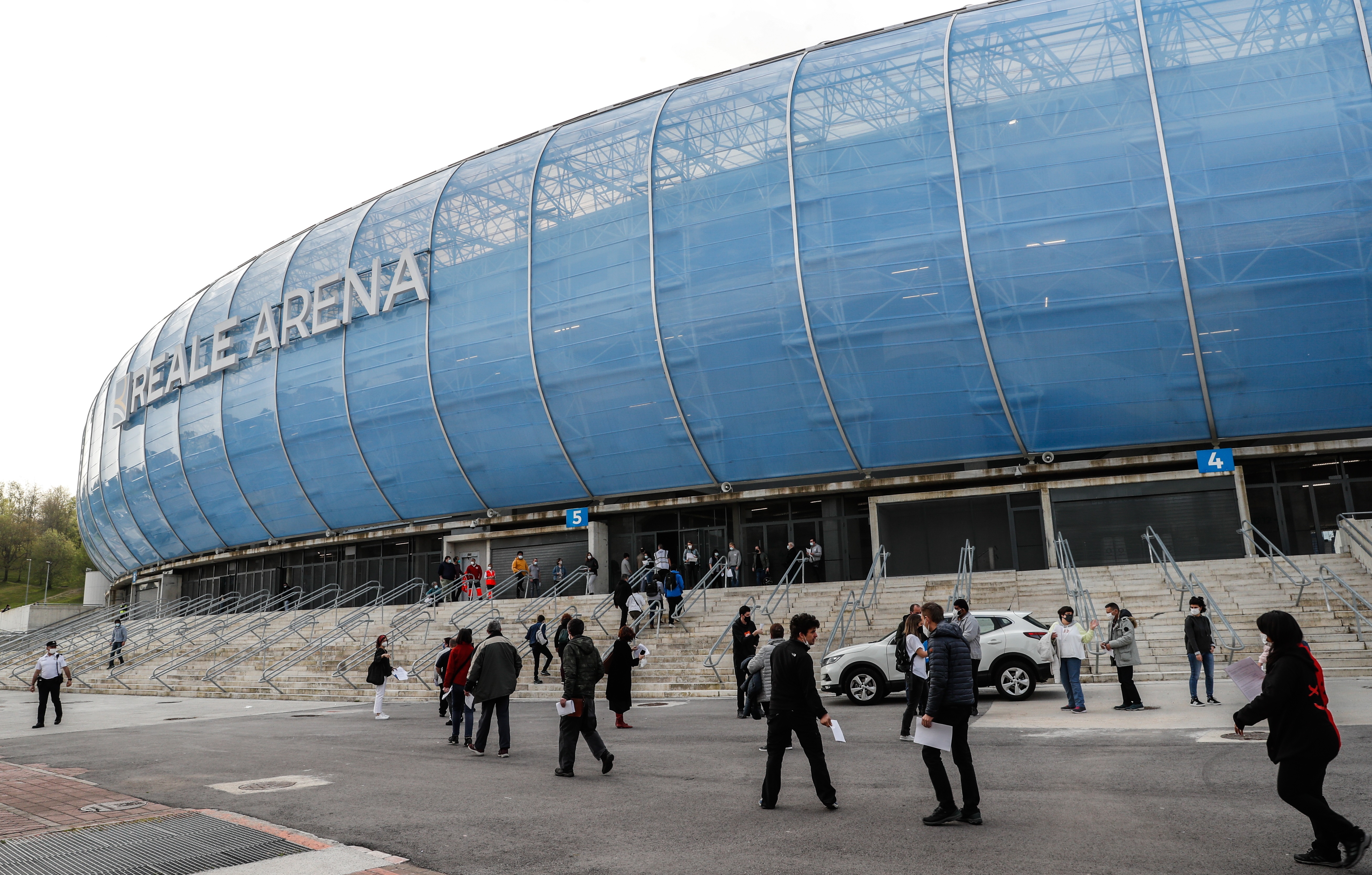 epa09106232 People queue to receive their vaccine against Covid-19 at Anoeta stadium in San Sebastian, Basque Country, Spain on 30 March 2021.  EPA-EFE/Juan Herrero