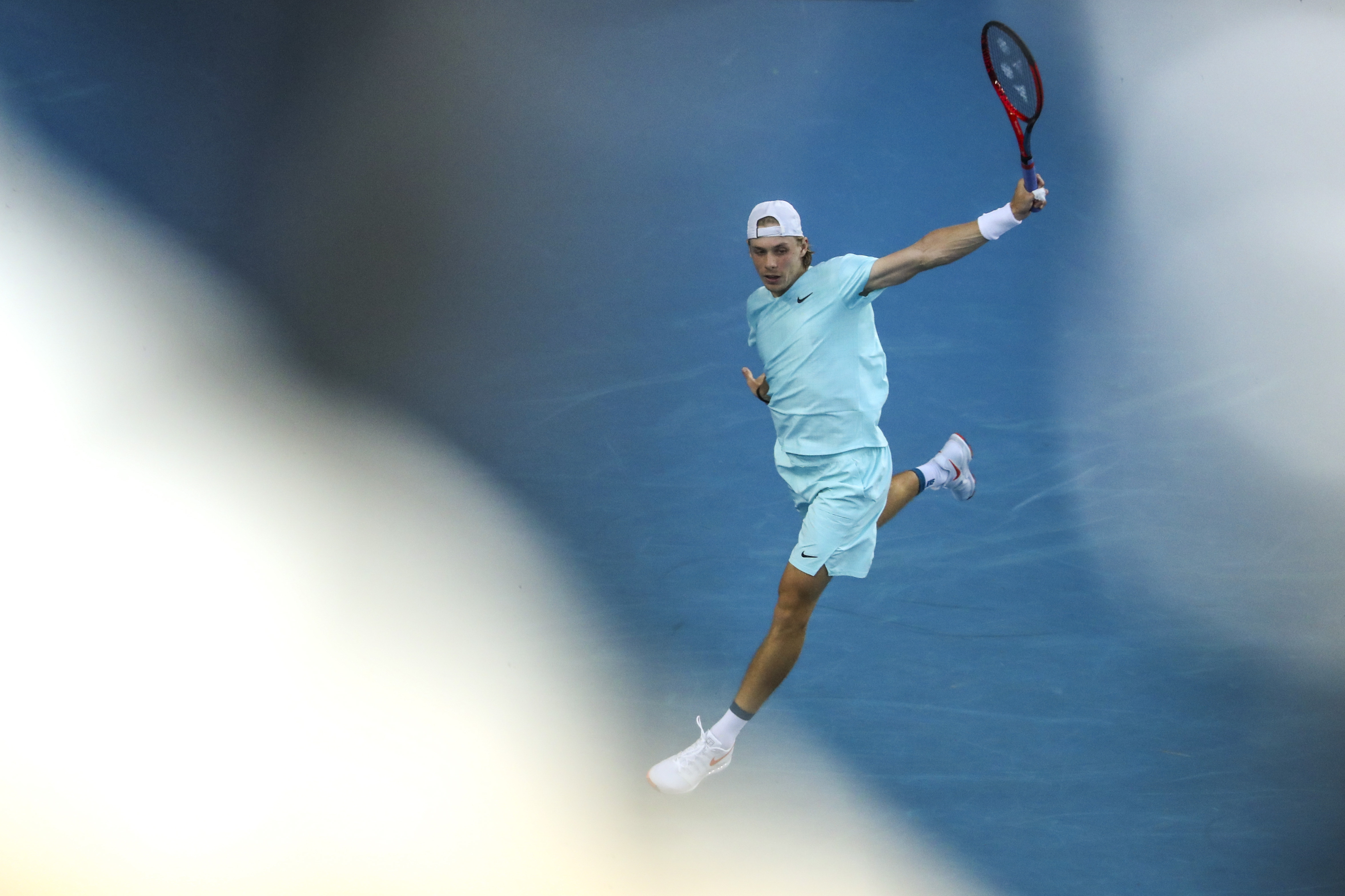 epa09006410 Denis Shapovalov of Canada in action during his men's singles third round match against Felix Auger-Aliassime of Canada at the Australian Open Grand Slam tennis tournament in Melbourne, Australia, 12 February 2021.  EPA-EFE/JASON O'BRIEN