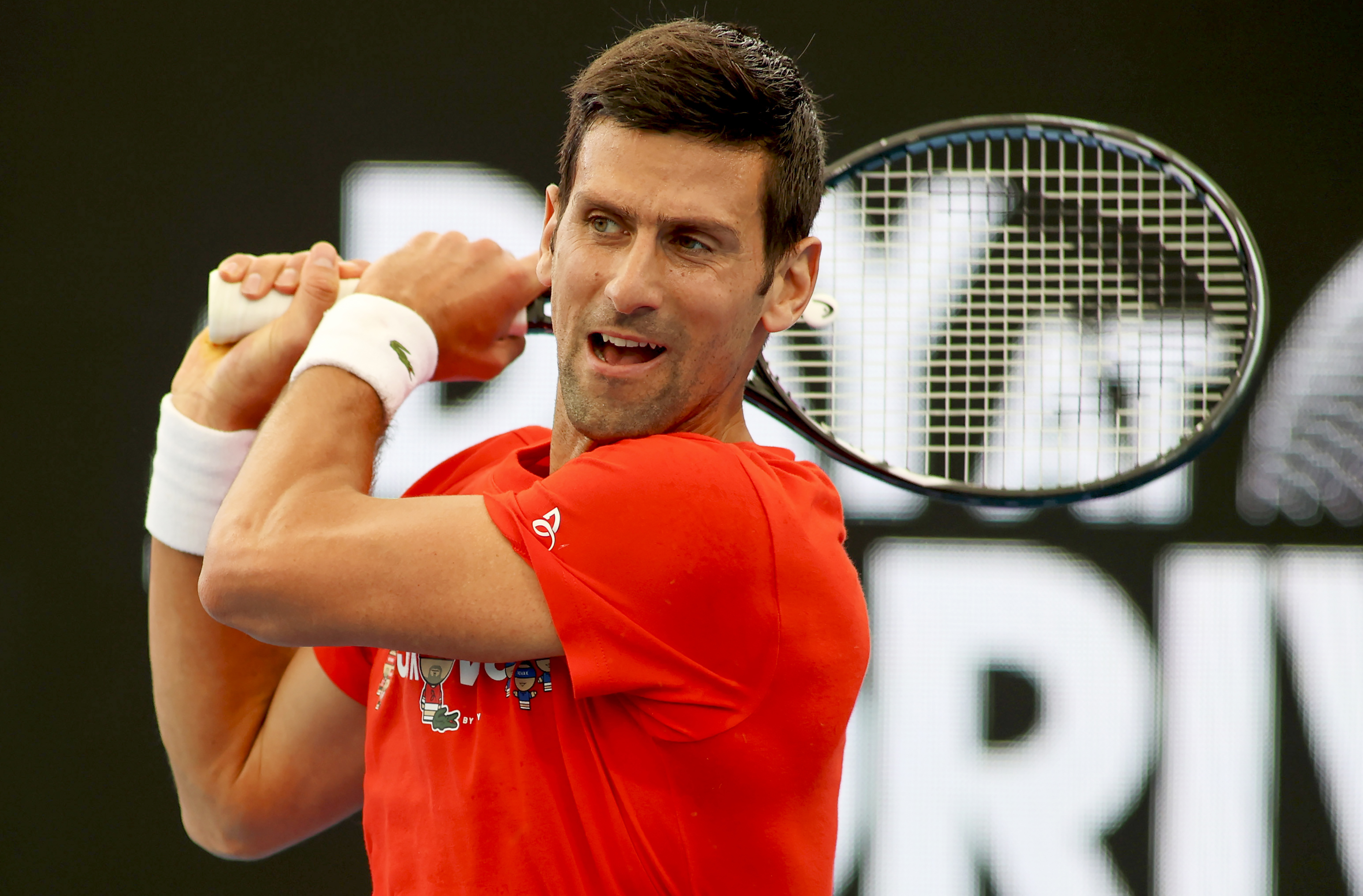 Serbia's Novak Djokovic makes a backhand return during an exhibition tennis event in Adelaide, Australia, Friday, Jan. 29. 2021. (Kelly Barnes/AAP Image via AP)