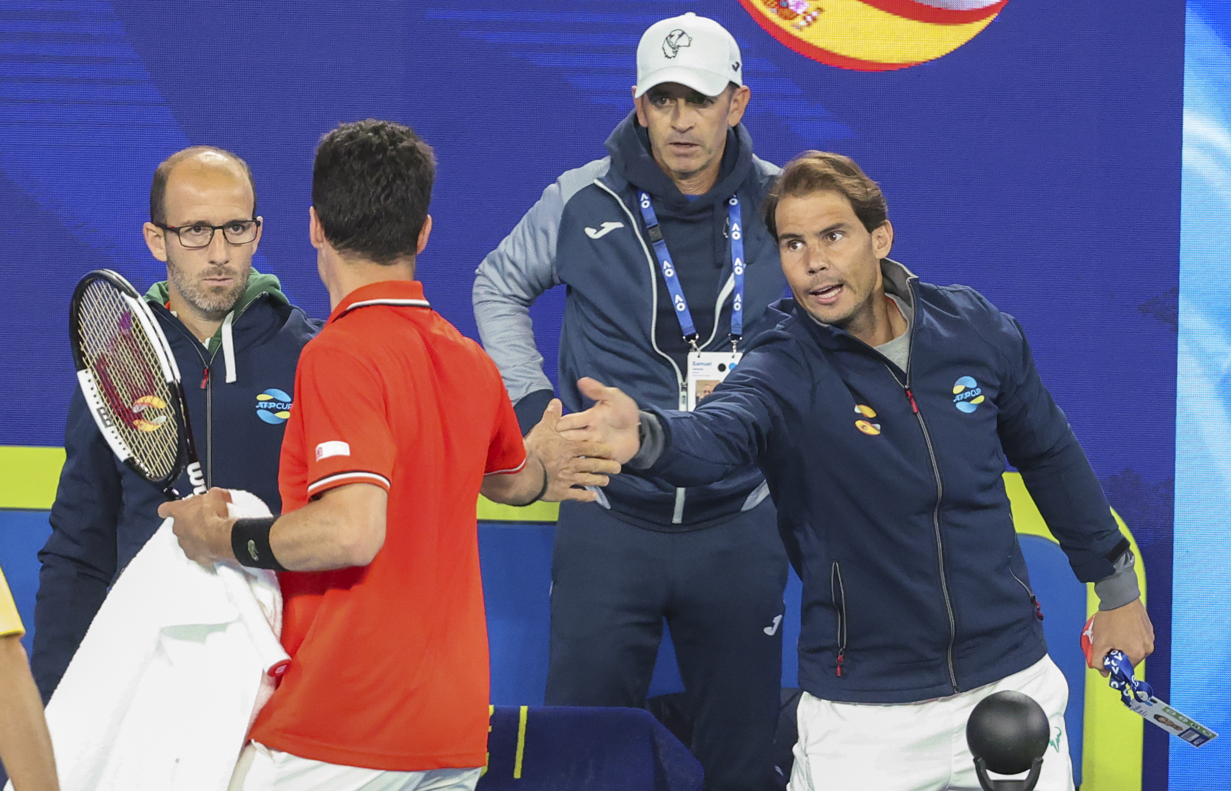 Spain's Rafael Nadal, right, gestures to teammate Roberto Bautista Agut during his ATP Cup match against Australia's Alex de Minaur in Melbourne, Australia, Tuesday, Feb. 2, 2021. (AP Photo/Hamish Blair)