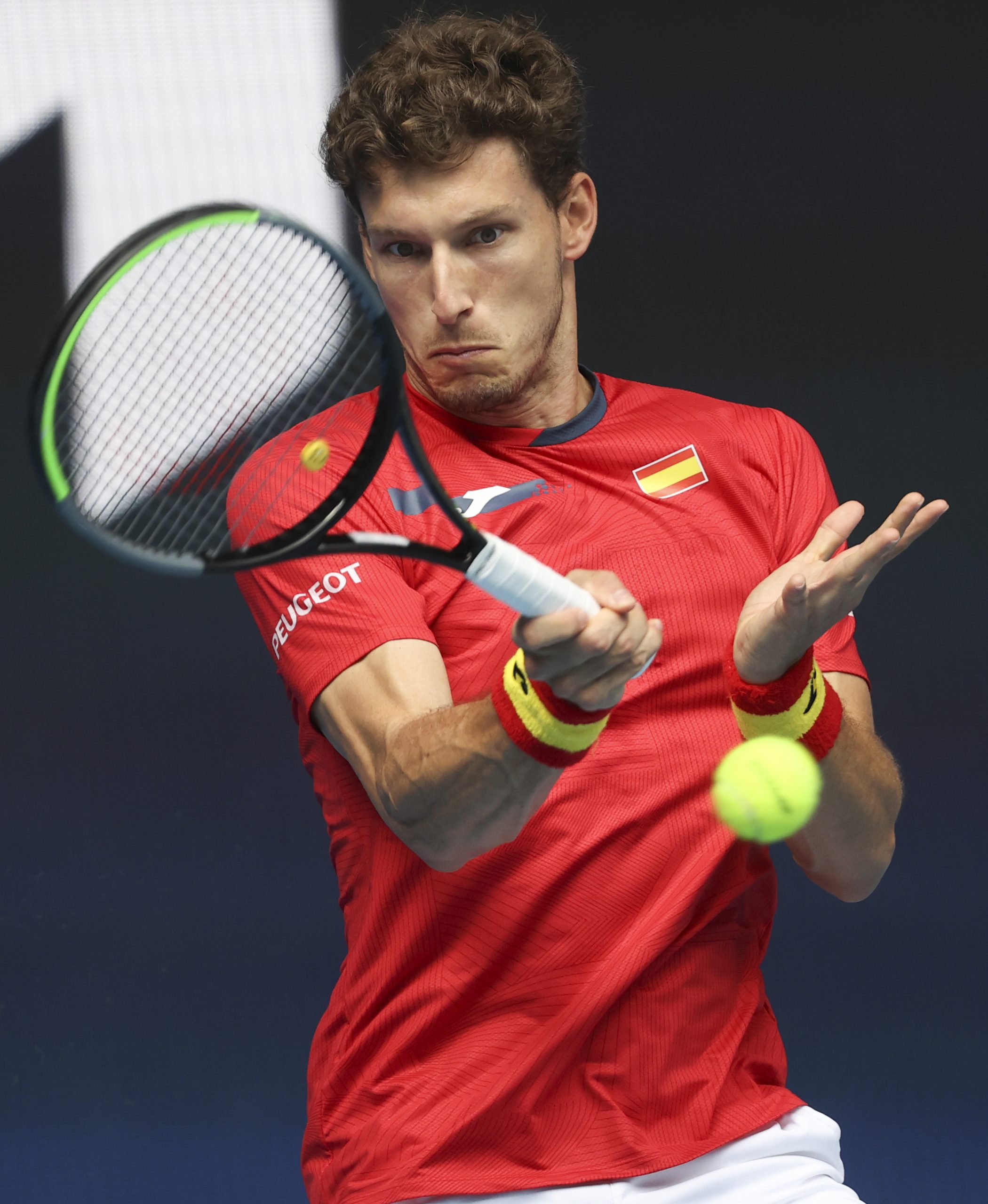 Spain's Pablo Carreno Busta makes a forehand return to Italy's Fabio Fognini during their ATP Cup semifinal match in Melbourne, Australia, Saturday, Feb. 6, 2021.(AP Photo/Hamish Blair)