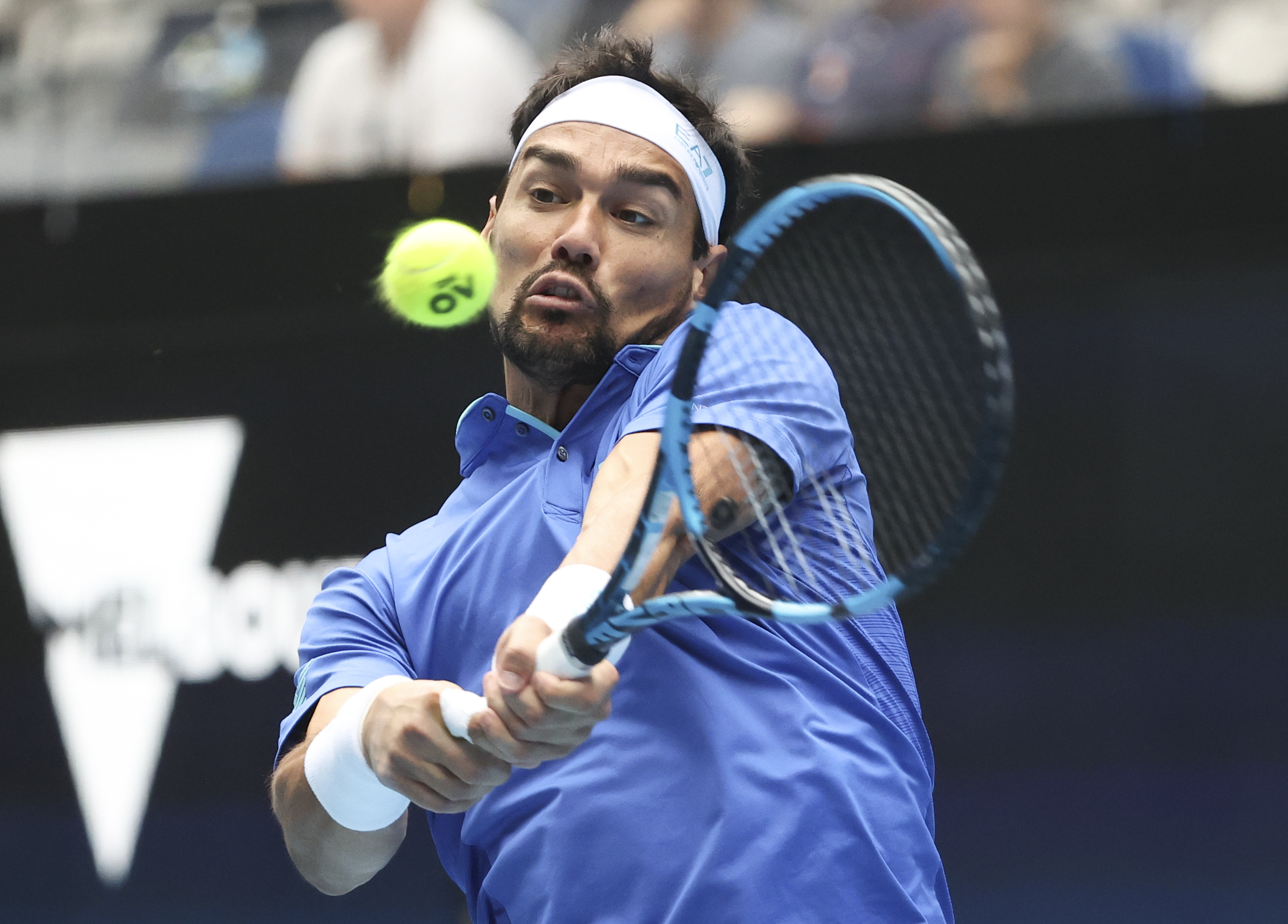 Italy's Fabio Fognini makes a backhand return to Spain's Pablo Carreno Busta during their ATP Cup semifinal match in Melbourne, Australia, Saturday, Feb. 6, 2021.(AP Photo/Hamish Blair)