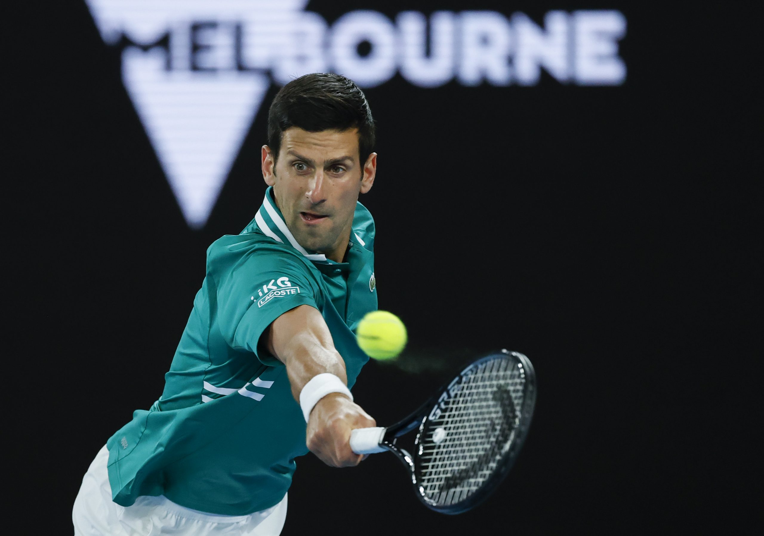 Serbia's Novak Djokovic makes a backhand return to France's Jeremy Chardy during their first round match at the Australian Open tennis championship in Melbourne, Australia, Monday, Feb. 8, 2021.(AP Photo/Rick Rycroft)