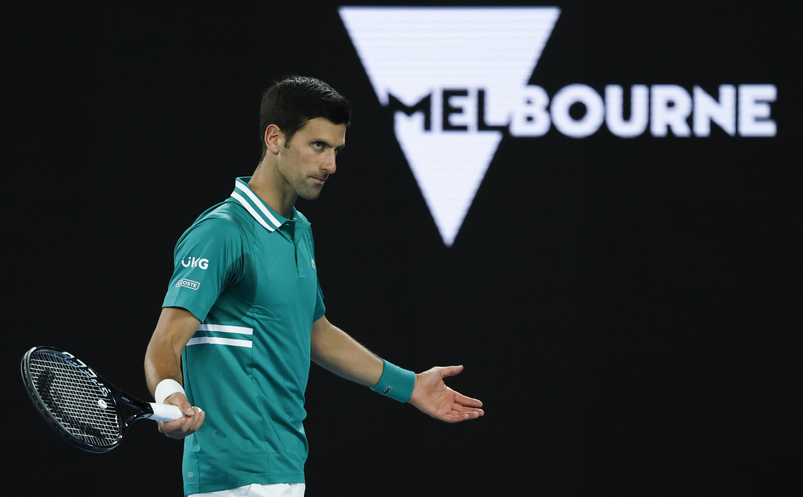 Serbia's Novak Djokovic gestures to France's Jeremy Chardy during their first round match at the Australian Open tennis championship in Melbourne, Australia, Monday, Feb. 8, 2021.(AP Photo/Rick Rycroft)