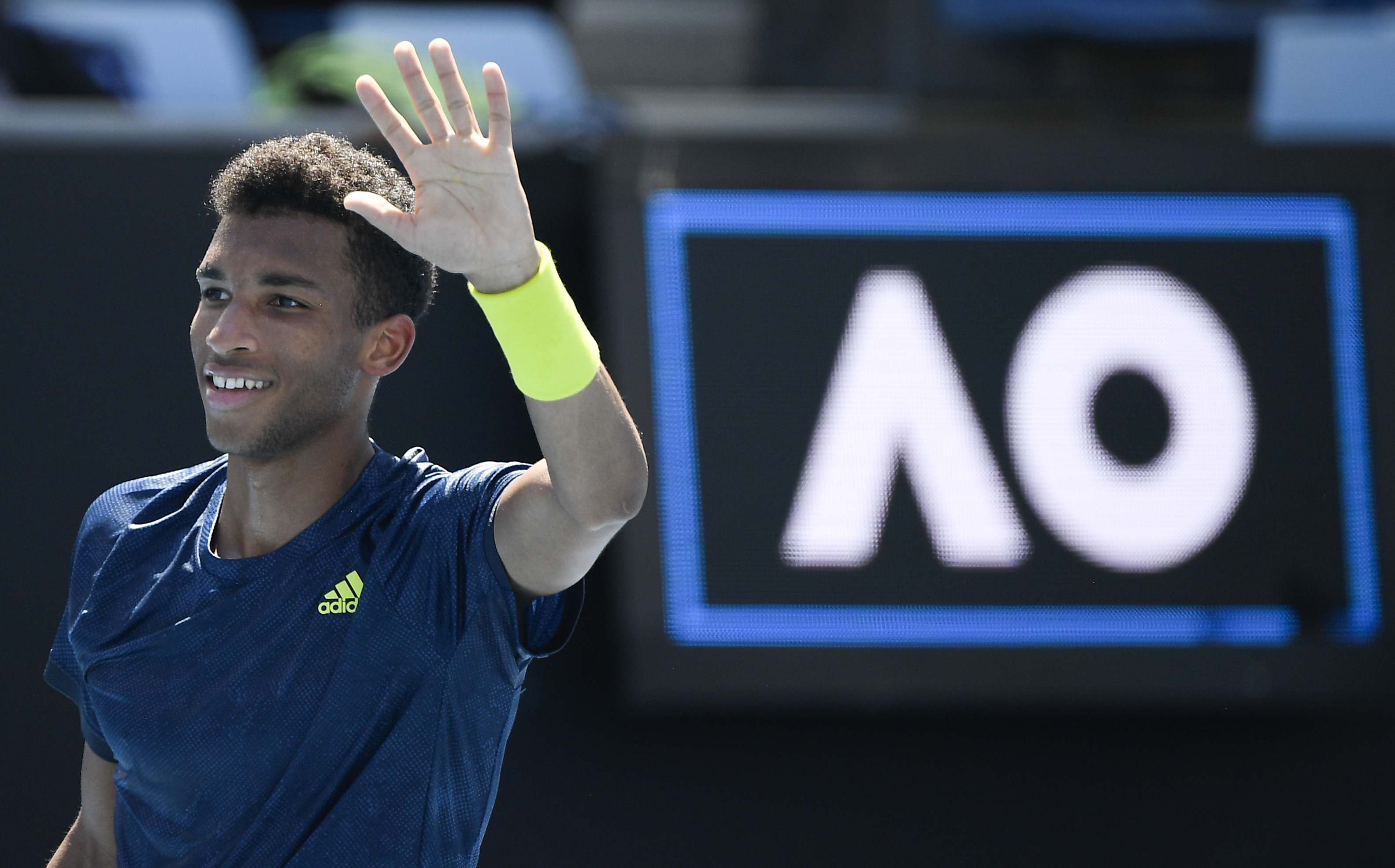 Canada's Felix Auger-Aliassime celebrates after defeating Australia's James Duckworth in their second round match at the Australian Open tennis championship in Melbourne, Australia, Wednesday, Feb. 10, 2021.(AP Photo/Andy Brownbill)