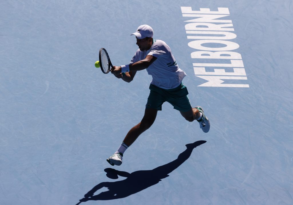 Serbia's Novak Djokovic makes a backhand return to United States' Frances Tiafoe during their second round match at the Australian Open tennis championship in Melbourne, Australia, Wednesday, Feb. 10, 2021.(AP Photo/Rick Rycroft)
