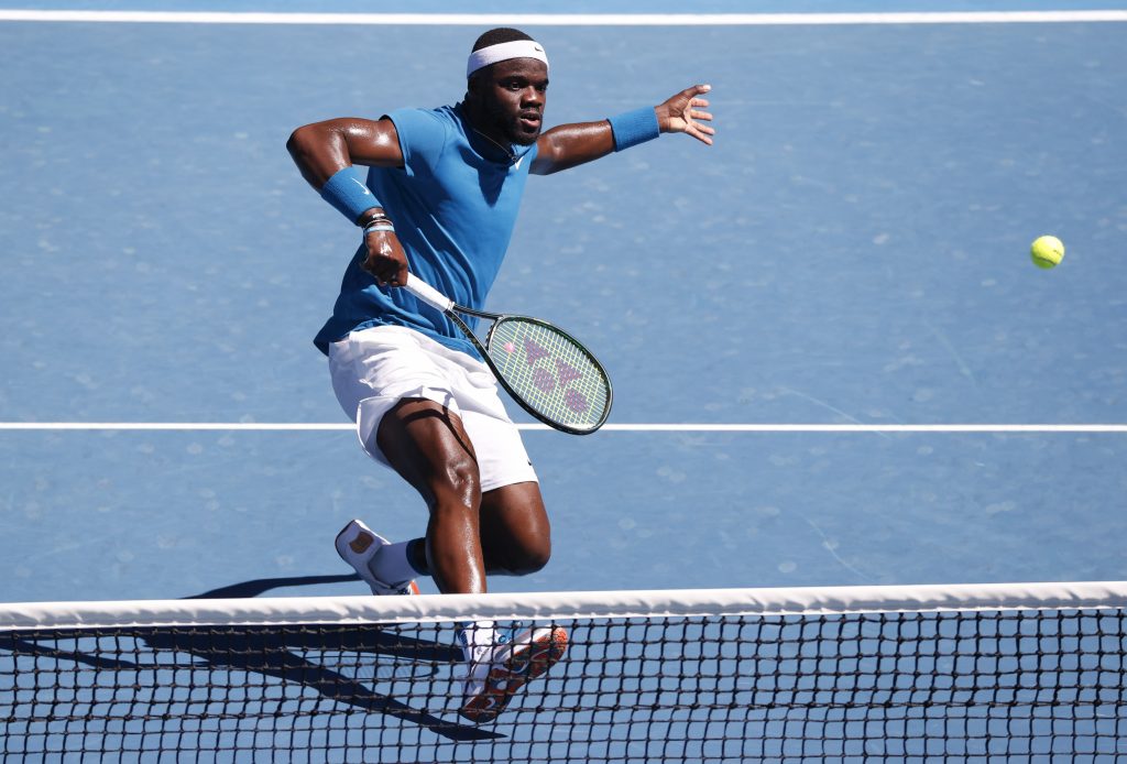 United States' Frances Tiafoe makes a backhand return to Serbia's Novak Djokovic during their second round match at the Australian Open tennis championship in Melbourne, Australia, Wednesday, Feb. 10, 2021.(AP Photo/Rick Rycroft)