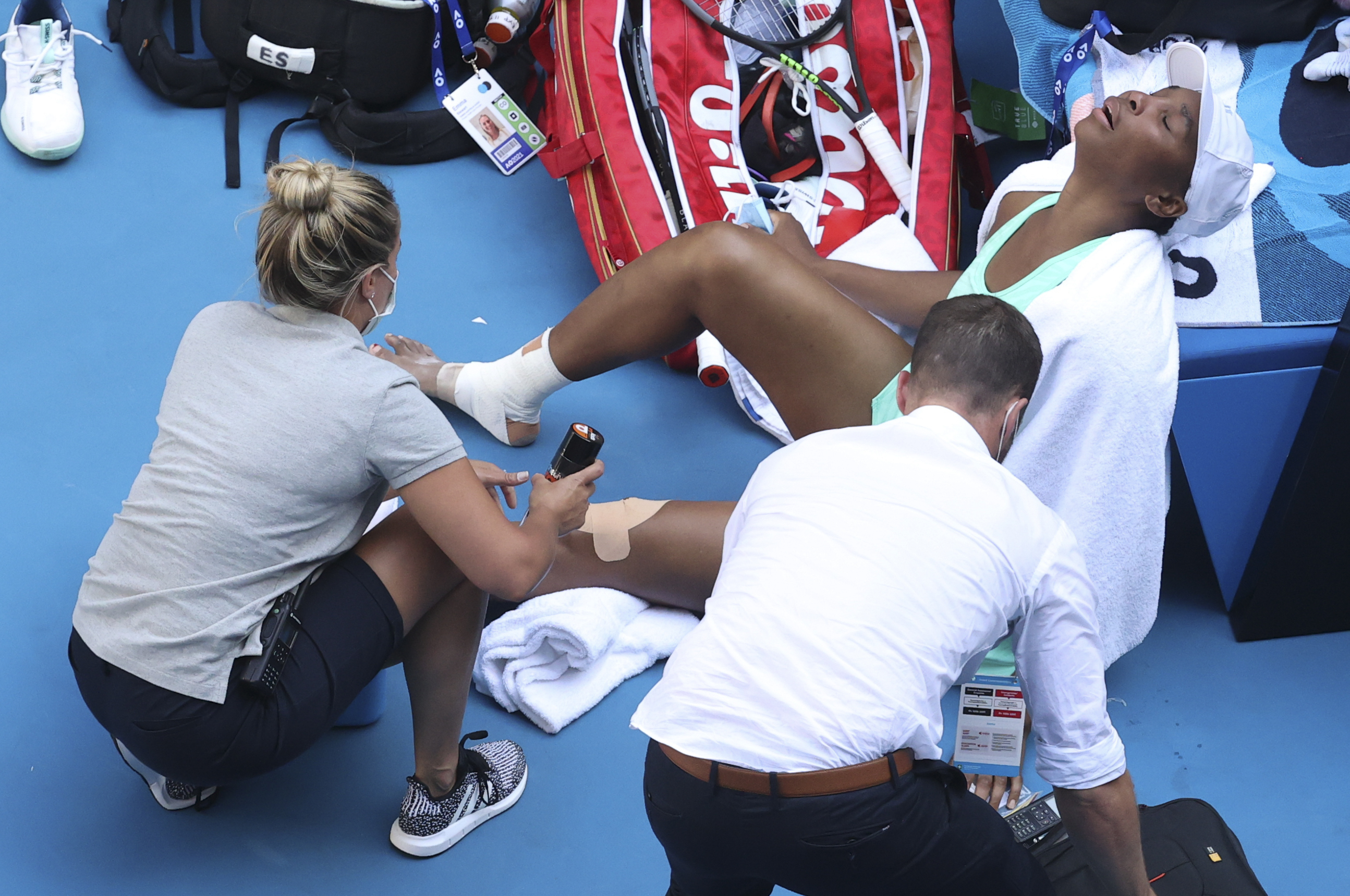 United States' Venus Williams reacts as she receives treatment to leg injuries during her second round match against Italy's Sara Errani at the Australian Open tennis championship in Melbourne, Australia, Wednesday, Feb. 10, 2021.(AP Photo/Hamish Blair)