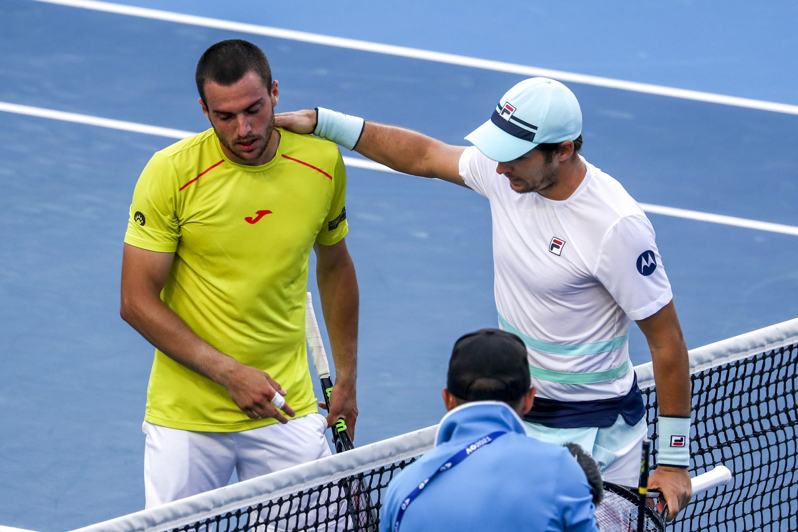 epa09006189 Pedro Martinez (L) of Spain and Dusan Lajovic of Serbia shake hands after their third round match at the Australian Open Grand Slam tennis tournament in Melbourne, Australia, 12 February 2021.  EPA-EFE/JASON O'BRIEN