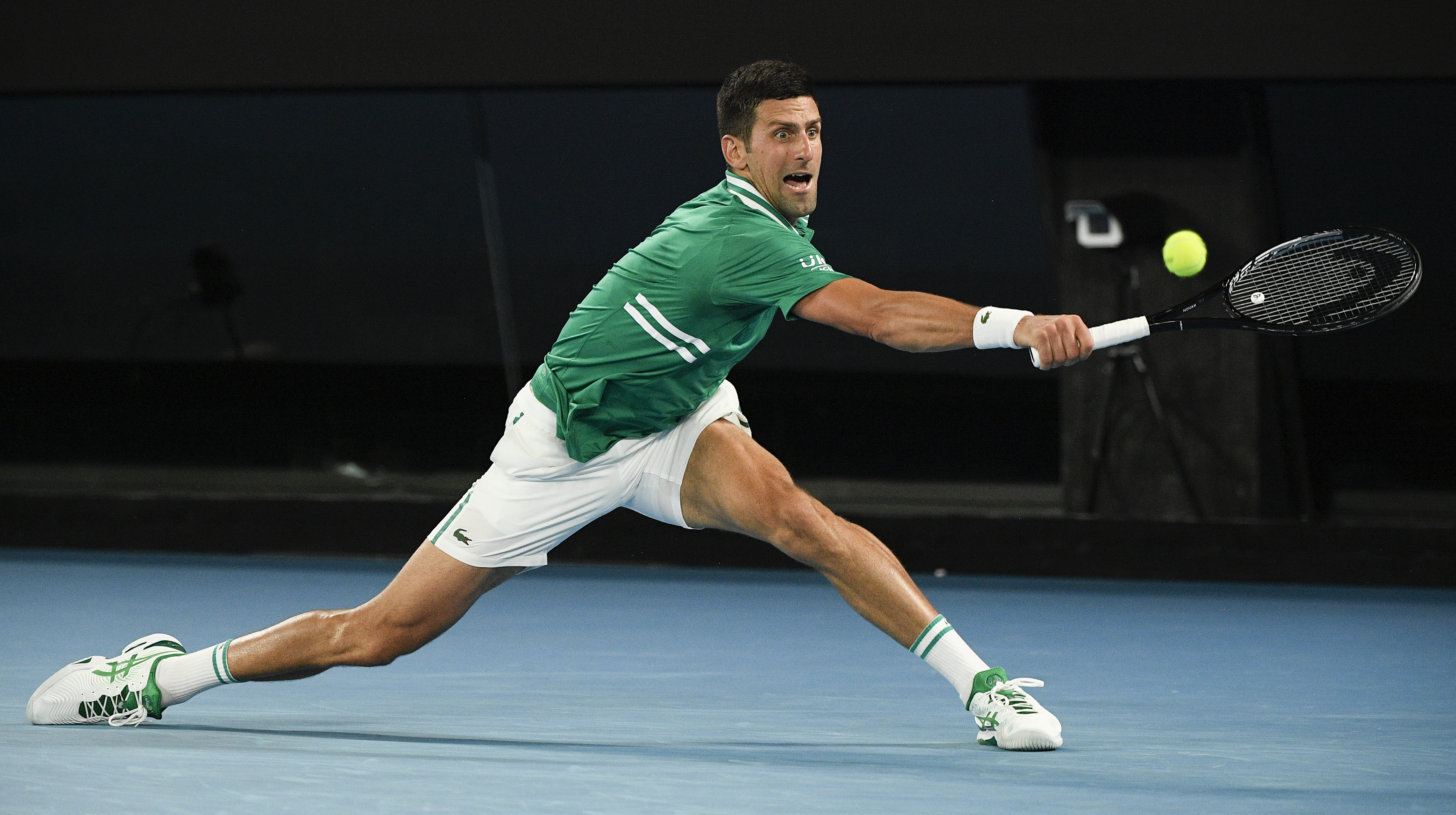 Serbia's Novak Djokovic hits a backhand return to Germany's Alexander Zverev during their quarterfinal match at the Australian Open tennis championship in Melbourne, Australia, Wednesday, Feb. 17, 2021.(AP Photo/Andy Brownbill)