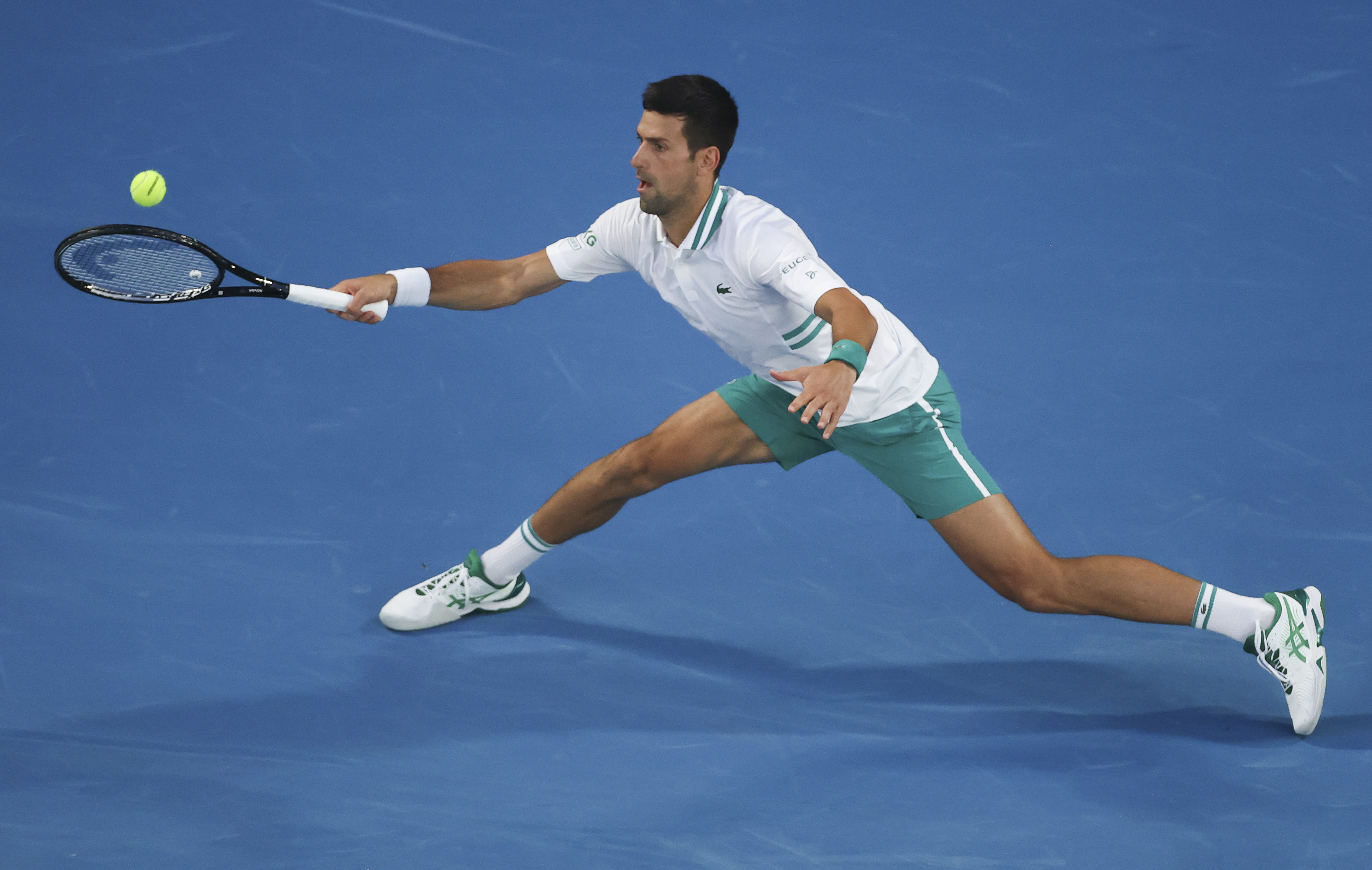 Serbia's Novak Djokovic hits a forehand return to Russia's Aslan Karatsev during their semifinal match at the Australian Open tennis championship in Melbourne, Australia, Thursday, Feb. 18, 2021.(AP Photo/Hamish Blair)