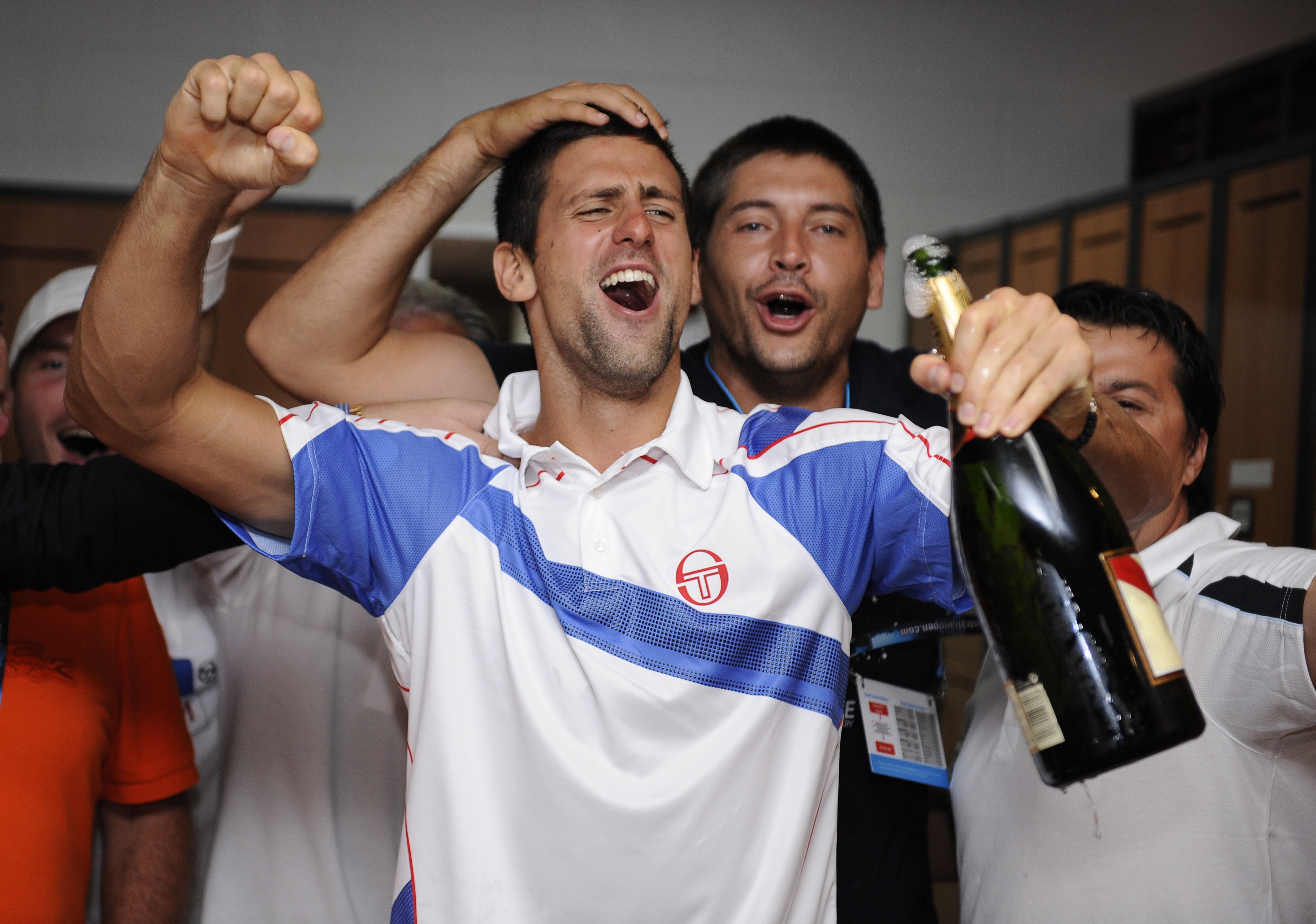 epa02556977 Novak Djokovic of Serbia celebrates after winning the men's singles championship on centre court at Rod Laver Arena against Andy Murray of Great Britain in Melbourne, Australia, 30 January 2011.  EPA/Ben Solomon / POOL
