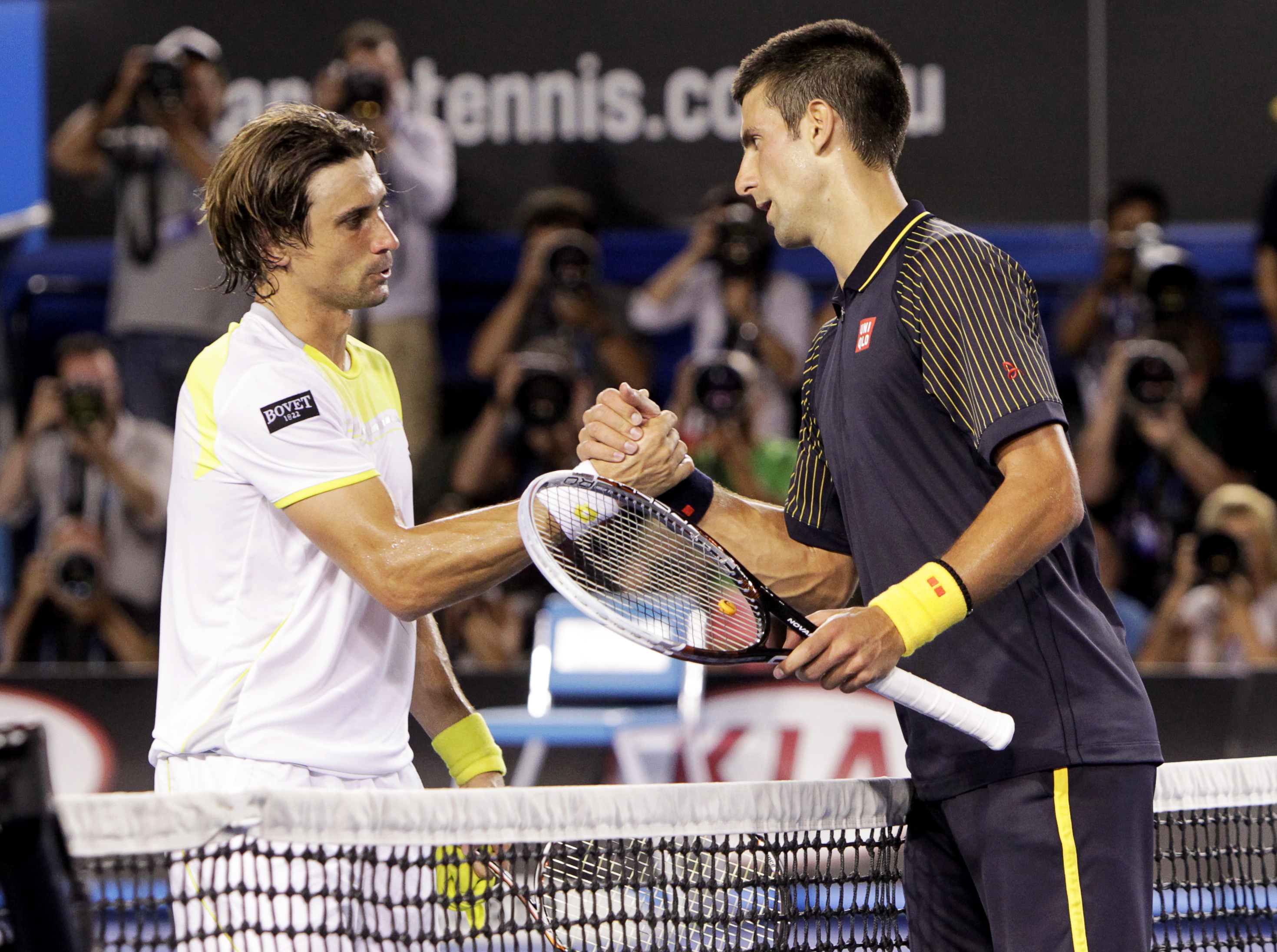 epa03553221 Novak Djokovic (R) of Serbia and David Ferrer of Spain shake hands after their semi final match at the Australian Open Grand Slam tennis tournament in Melbourne, Australia, 24 January 2013. Djokovic won in three sets.  EPA/Mast Irham