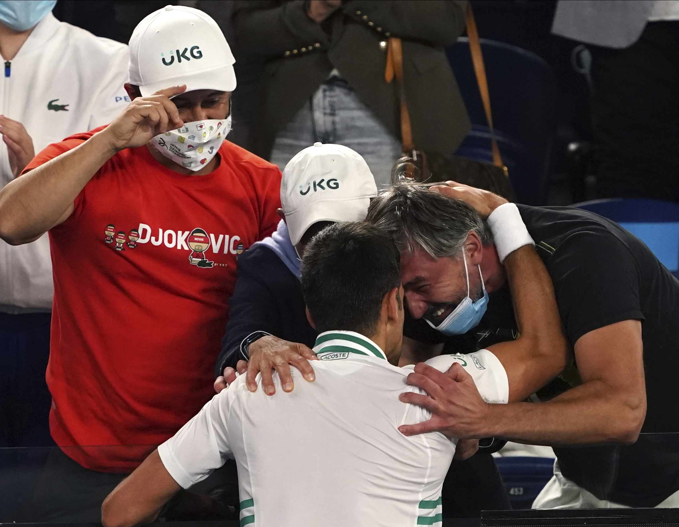 Serbia's Novak Djokovic celebrates with his support team after defeating Russia's Daniil Medvedev during the men's singles final at the Australian Open tennis championship in Melbourne, Australia, Sunday, Feb. 21, 2021.(AP Photo/Mark Dadswell)