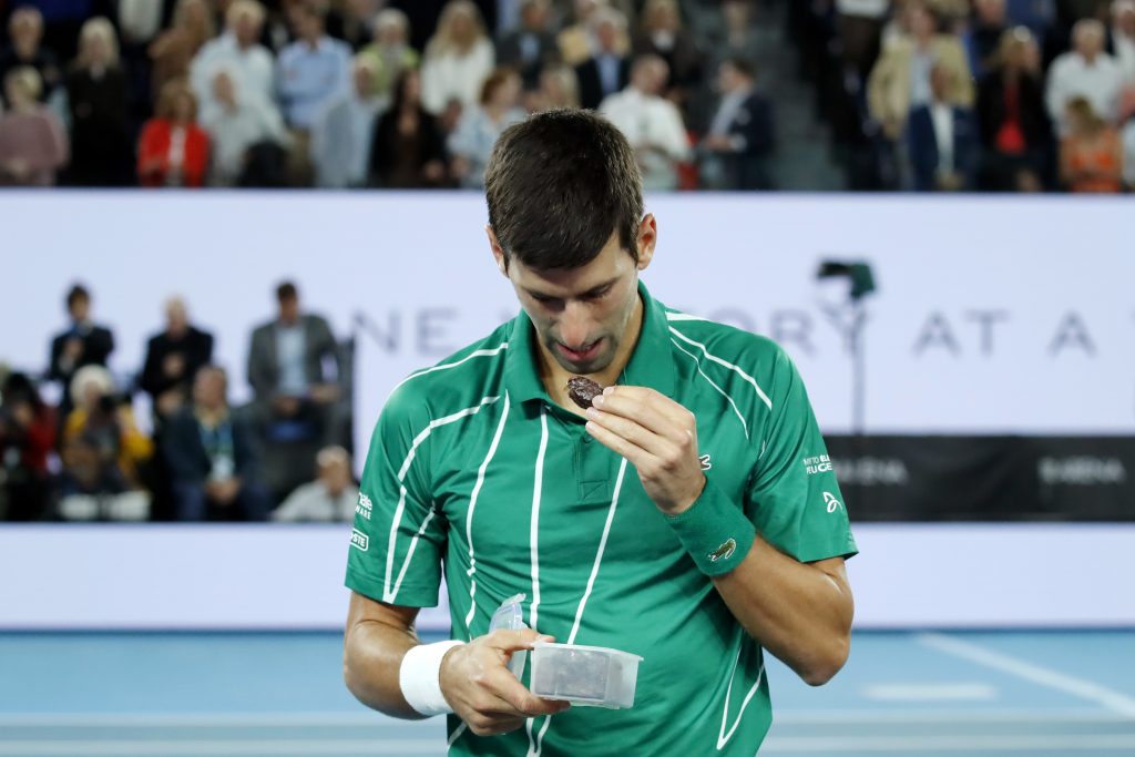 epa08187621 Novak Djokovic of Serbia eats a snack during a break in his men's singles final match against Dominic Thiem of Austria at the Australian Open Grand Slam tennis tournament in Melbourne, Australia, 02 February 2020. EPA-EFE/FRANCIS MALASIG