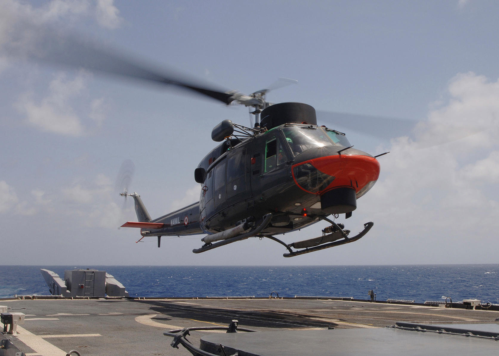 Sea (July 18, 2005) - A Peruvian Agusta AB 212 helicopter approaches the flight deck of the guided missile cruiser USS Thomas S. Gates (CG 51) during a helicopter cross deck training exercise in the Caribbean Sea. Thomas S. Gates is part of a multinationa