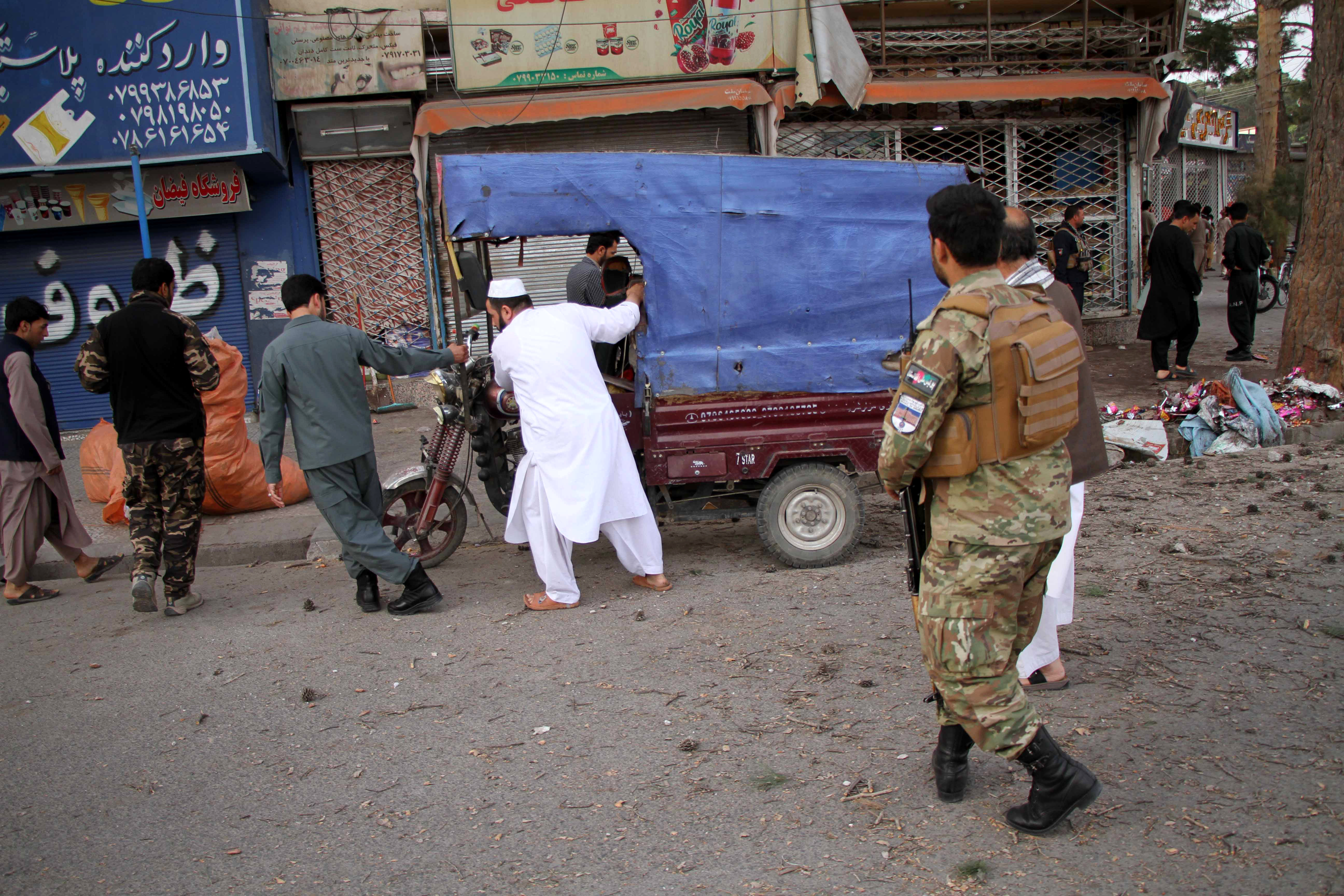 epa09169999 Afghan security officials inspect the scene of roadside mine explosion in Herat, Afghanistan, 30 April 2021. At least four civilians were wounded in roadside mine explosions in Afghanistan's western city of Herat.  EPA-EFE/JALIL REZAYEE