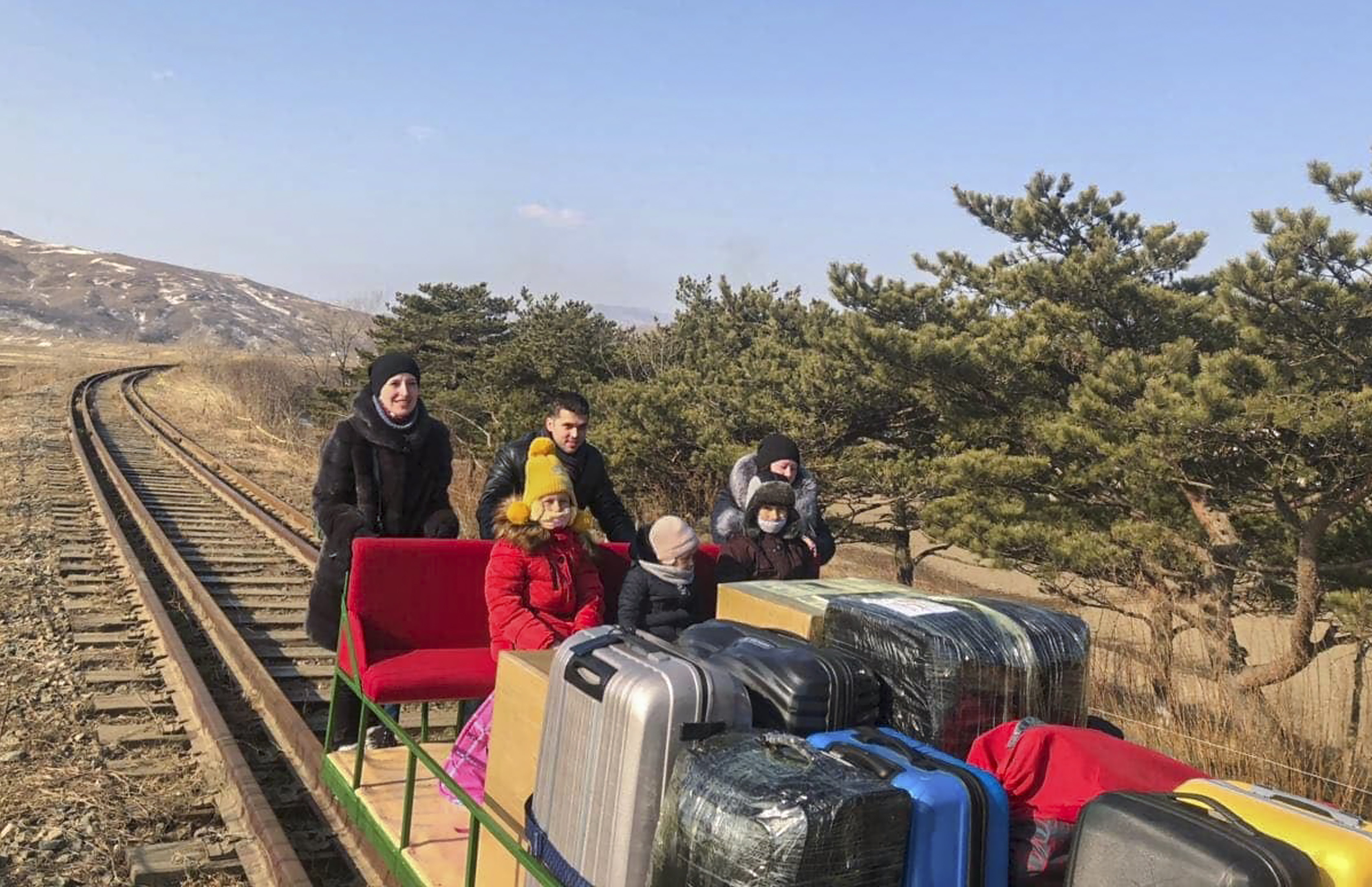 Russian diplomats arive from the North Korea on hand-pushed rail trolley