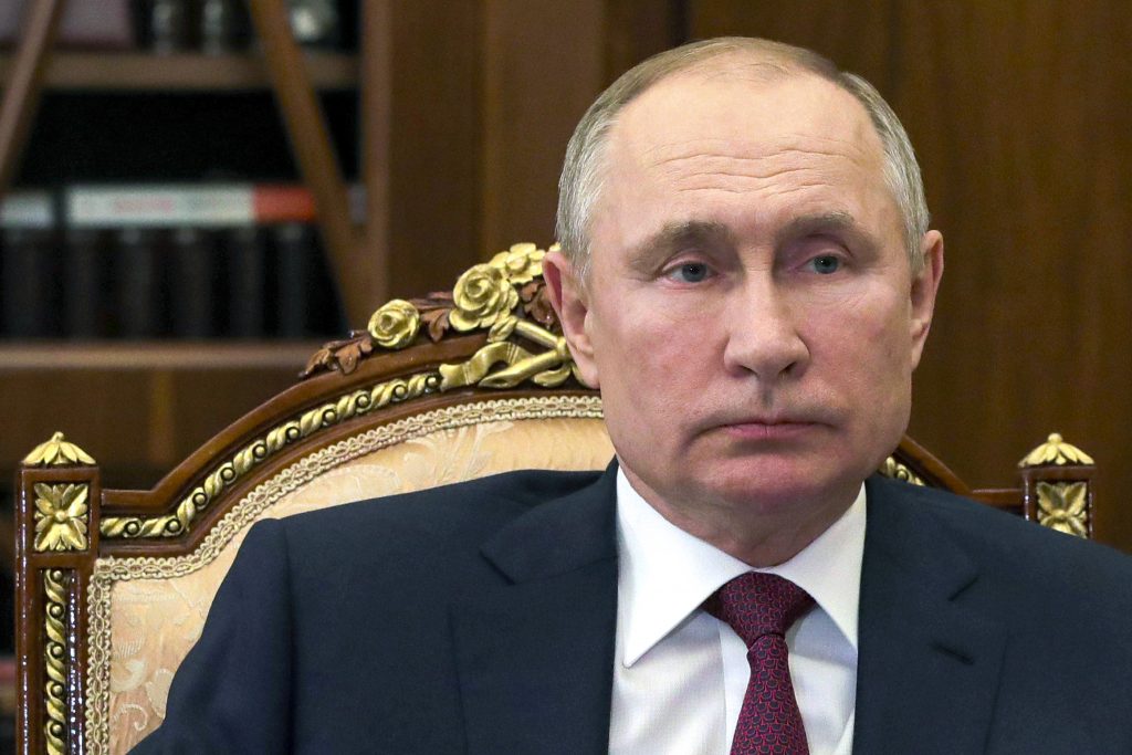 Russian President Vladimir Putin listens to Russian Roscosmos head Dmitry Rogozin during a meeting in the Kremlin in Moscow, Russia, Saturday, Feb. 20, 2021. (Mikhail Klimentyev, Sputnik, Kremlin Pool Photo via AP)