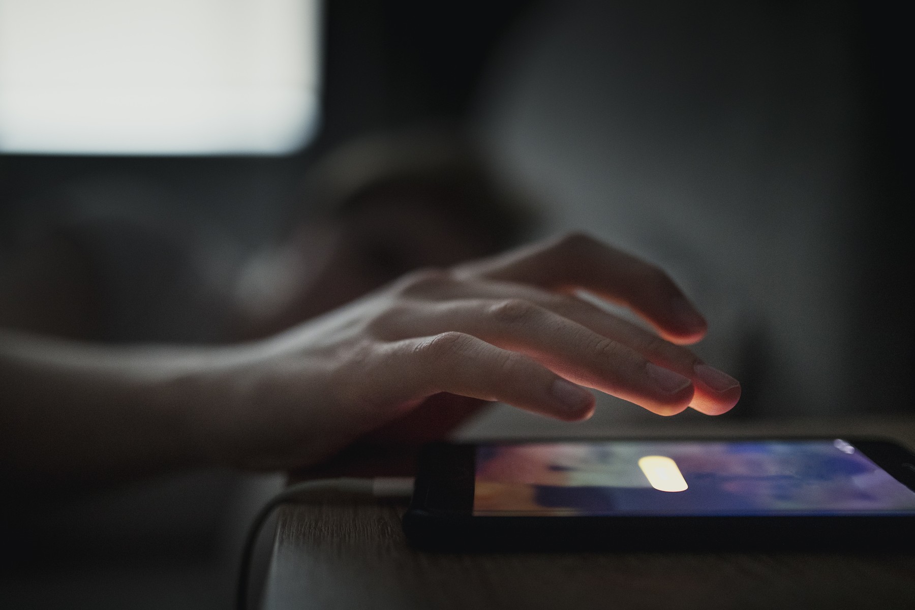 Unrecognisable male going to touch the snooze button on his mobile phone. The alarm is waking him up in the morning.,Image: 376045128, License: Royalty-free, Restrictions: , Model Release: yes, Credit line: Graham Oliver / Panthermedia / Profimedia
