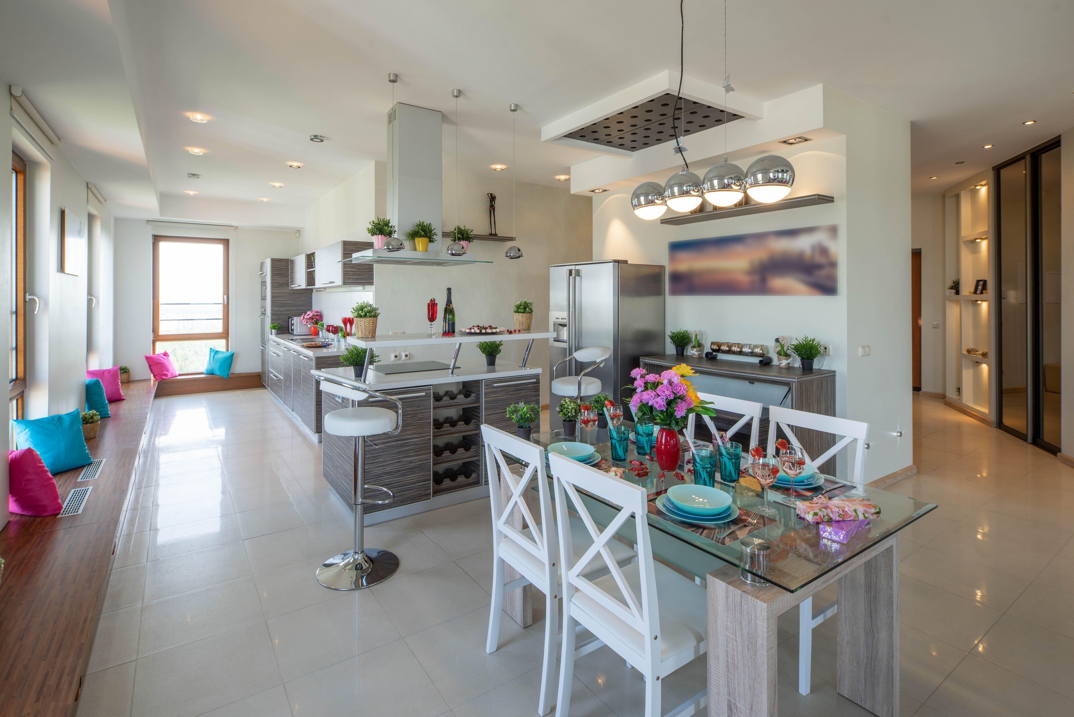 Kitchen in spacious modern luxury apartment. Interior in light tones. Laid table. Kitchen set.