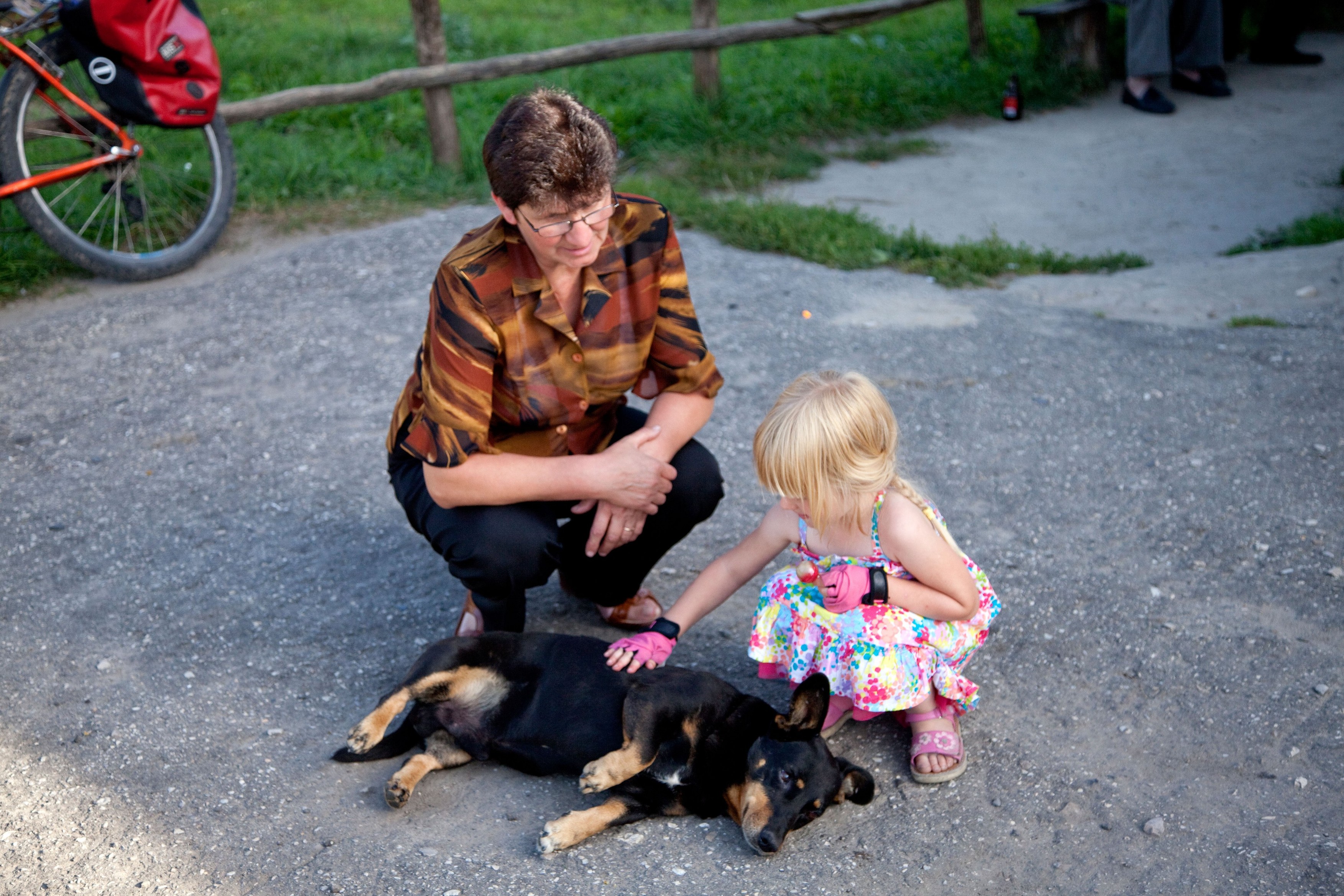 Grocery store owner comes outside to visit one of her best customers petting her pet dog age 50 and 4. Mala Wola Central Poland