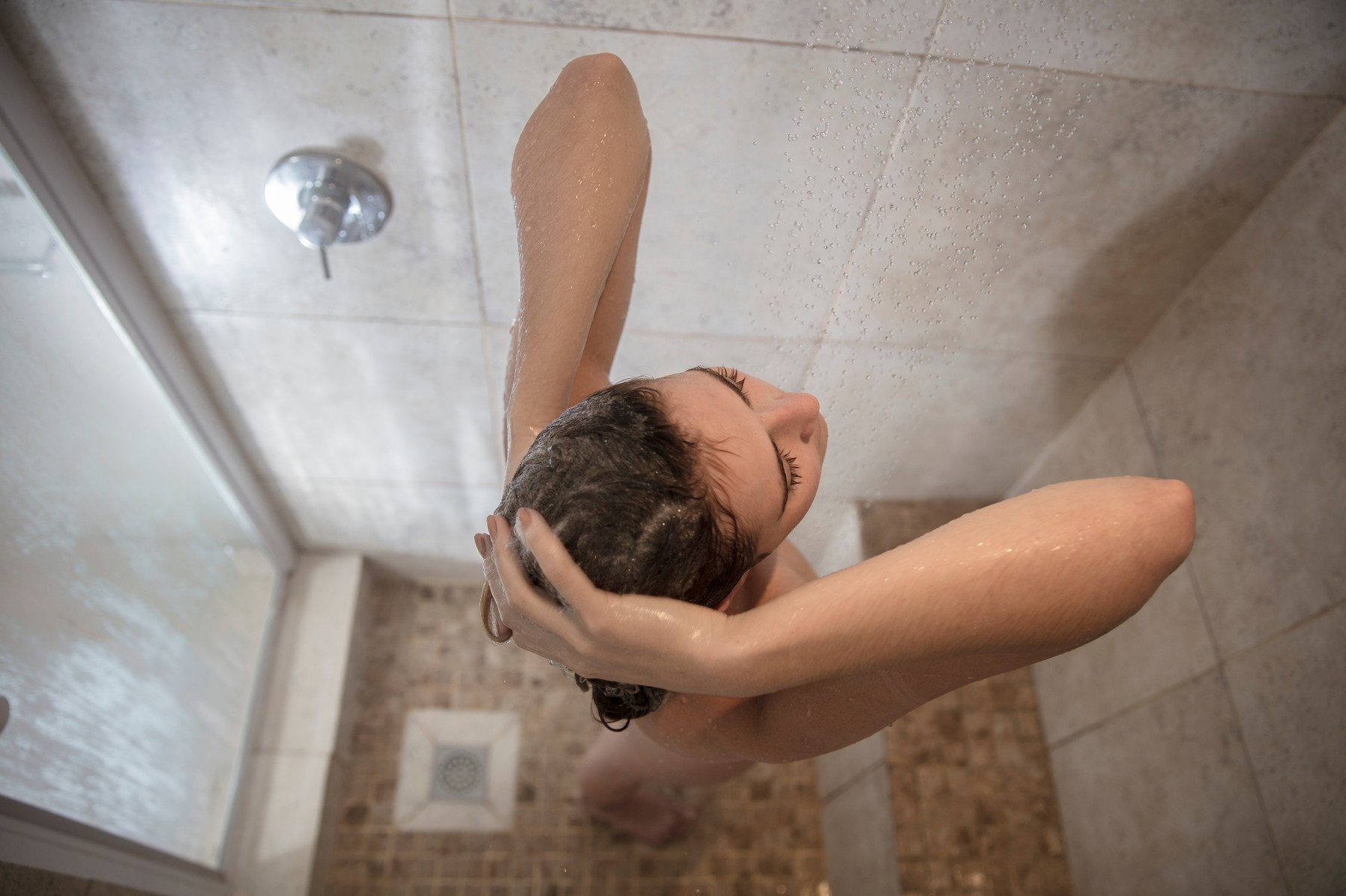 Overhead view of young woman in showering