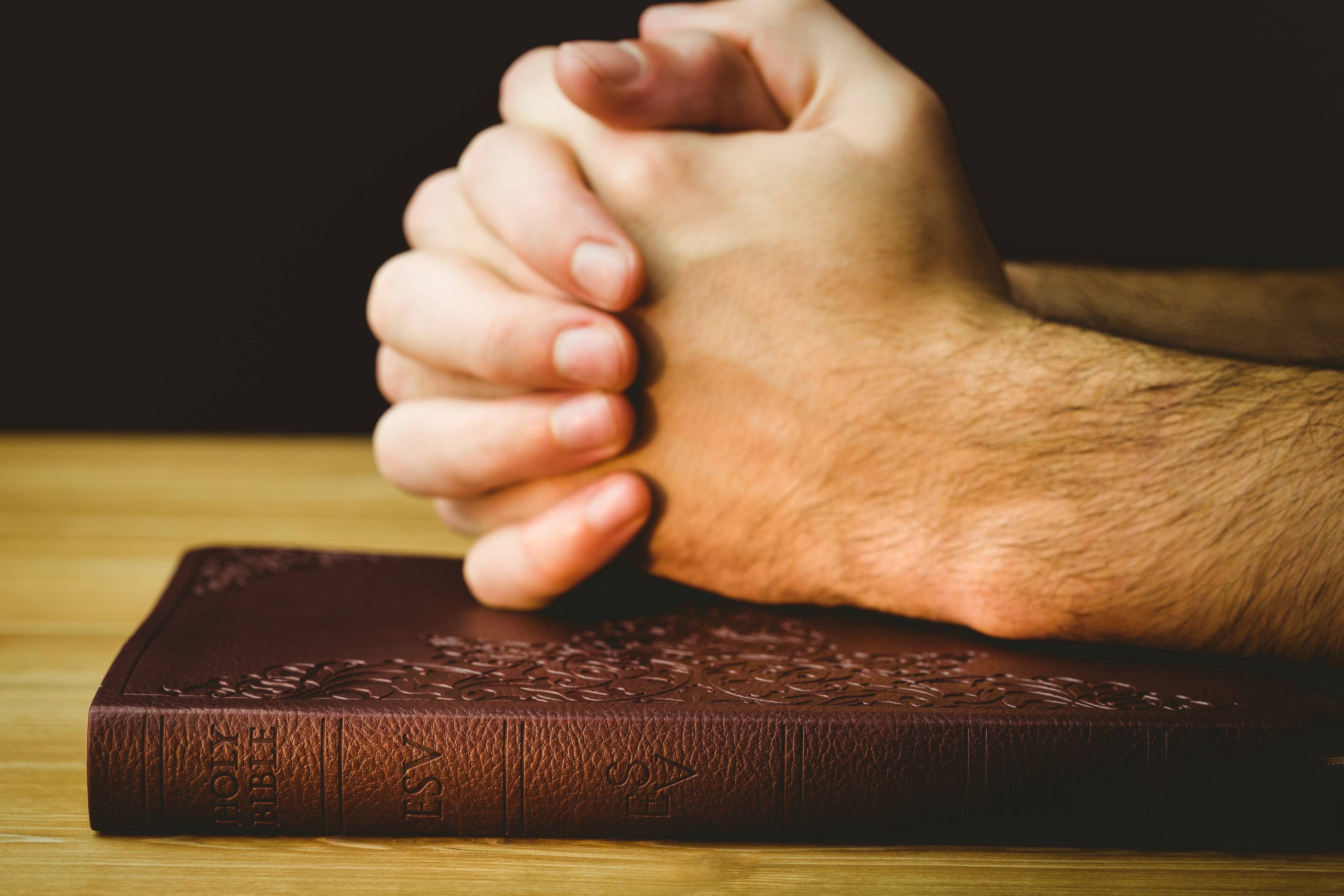 Man praying over his bible on wooden table,Image: 231359700, License: Royalty-free, Restrictions: , Model Release: no, Credit line: - / Wavebreak / Profimedia
