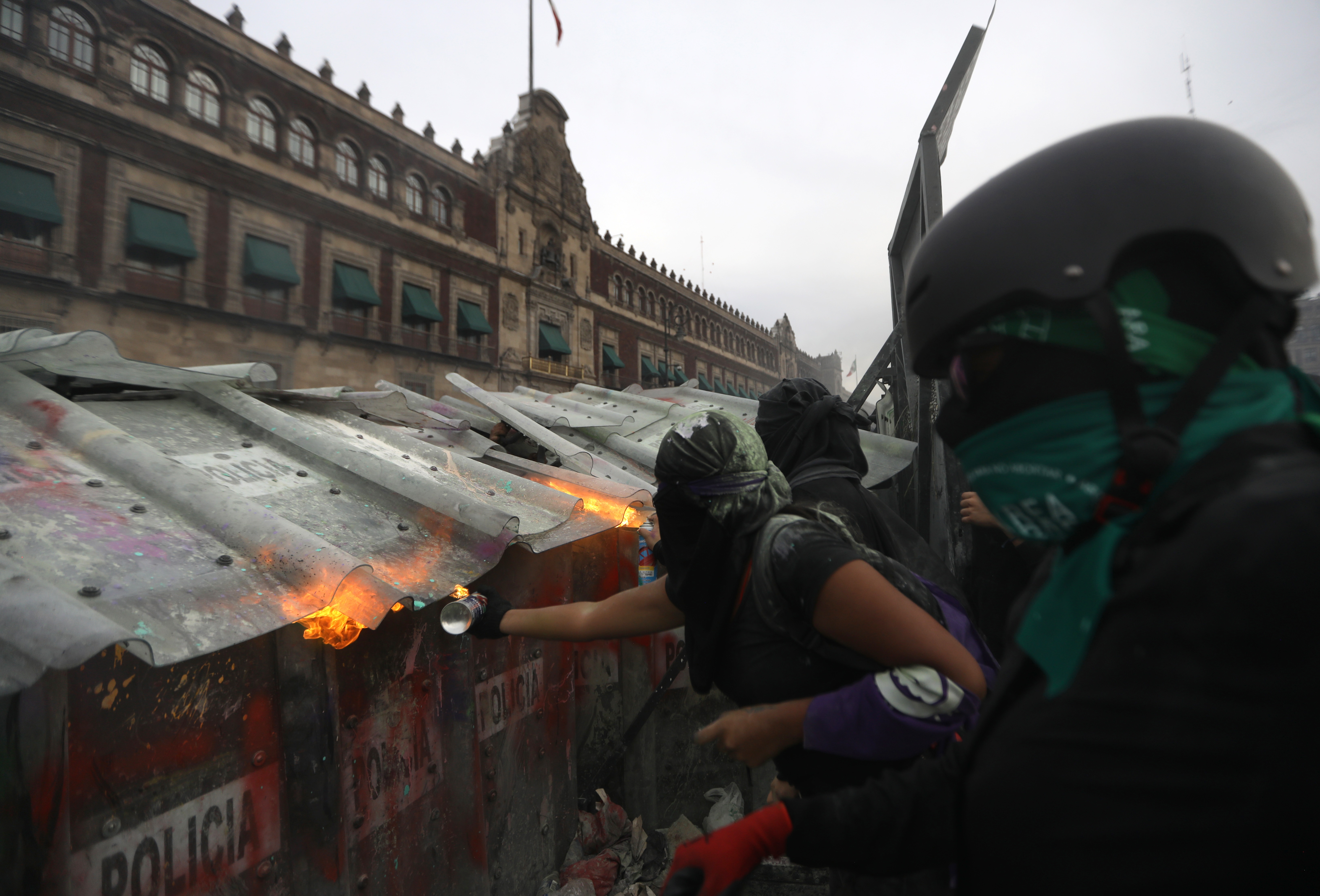 epa09063107 Activists clash with police during a protest against the alarming numbers of femicides, on International Women's Day at Plaza del Zocalo in Mexico City, Mexico, 08 March 2021.  EPA-EFE/Sashenka Gutierrez