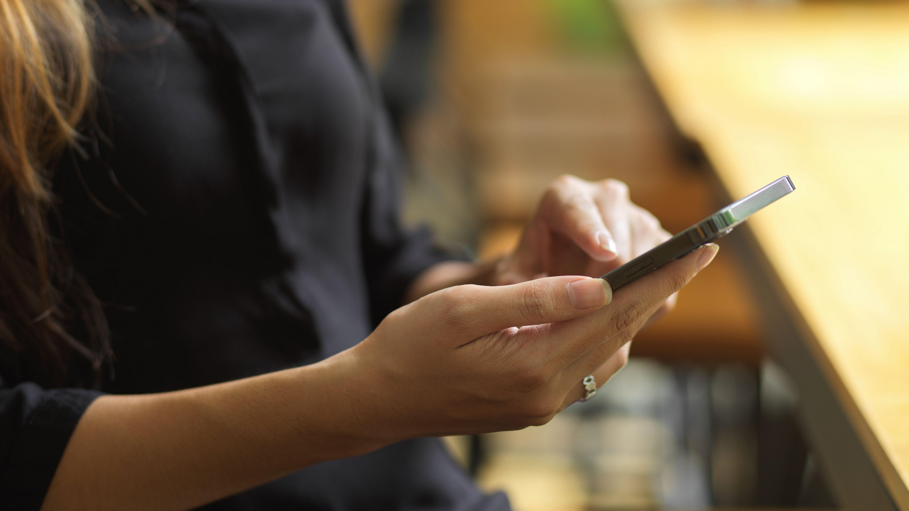 Businesswoman checking business email via smartphone, female ordering food delivery via mobile application, close up