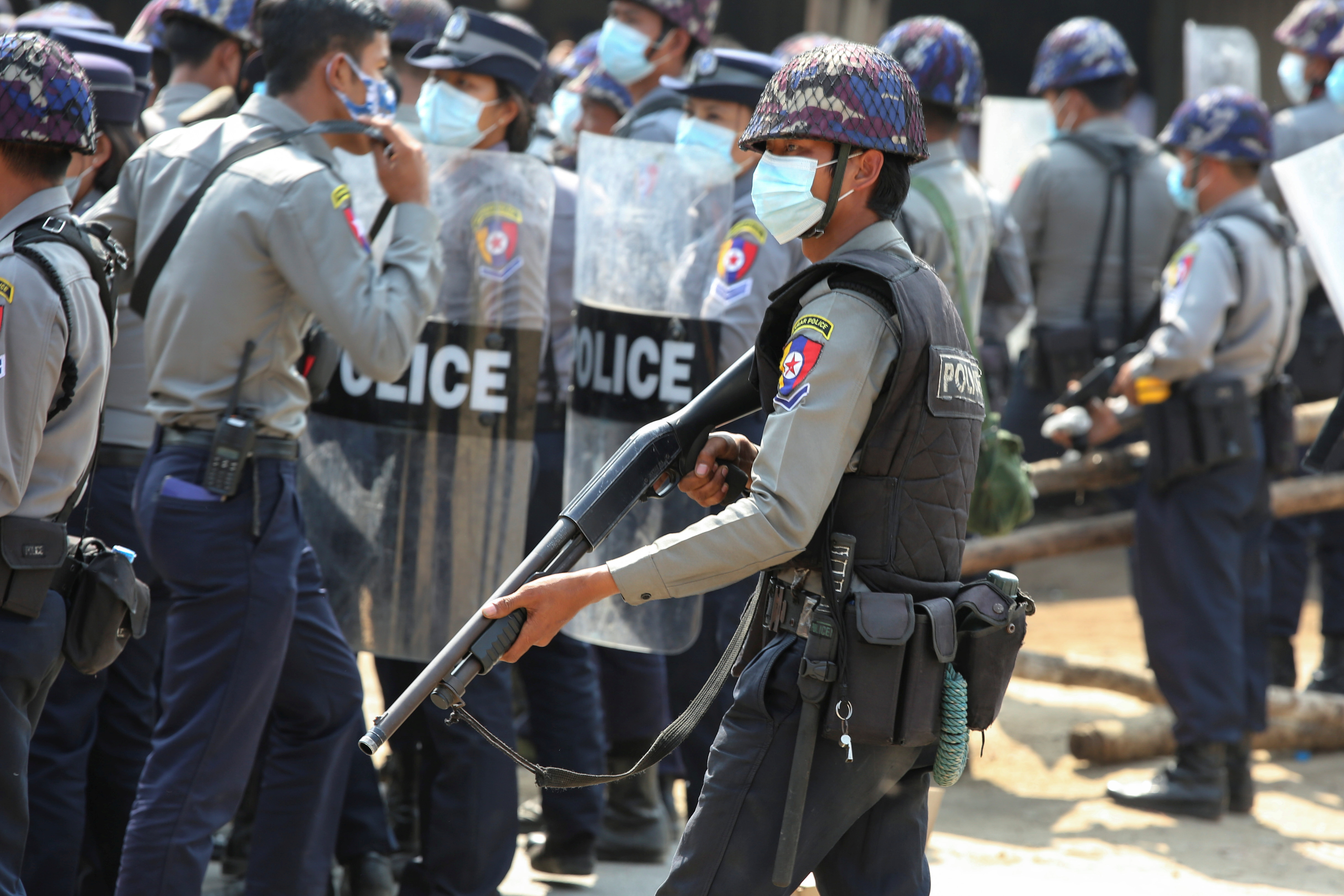 26022021 A police officer holds a weapon during a protest against the military coup in Naypyitaw, Myanmar February 26, 2021. REUTERS/Stringer