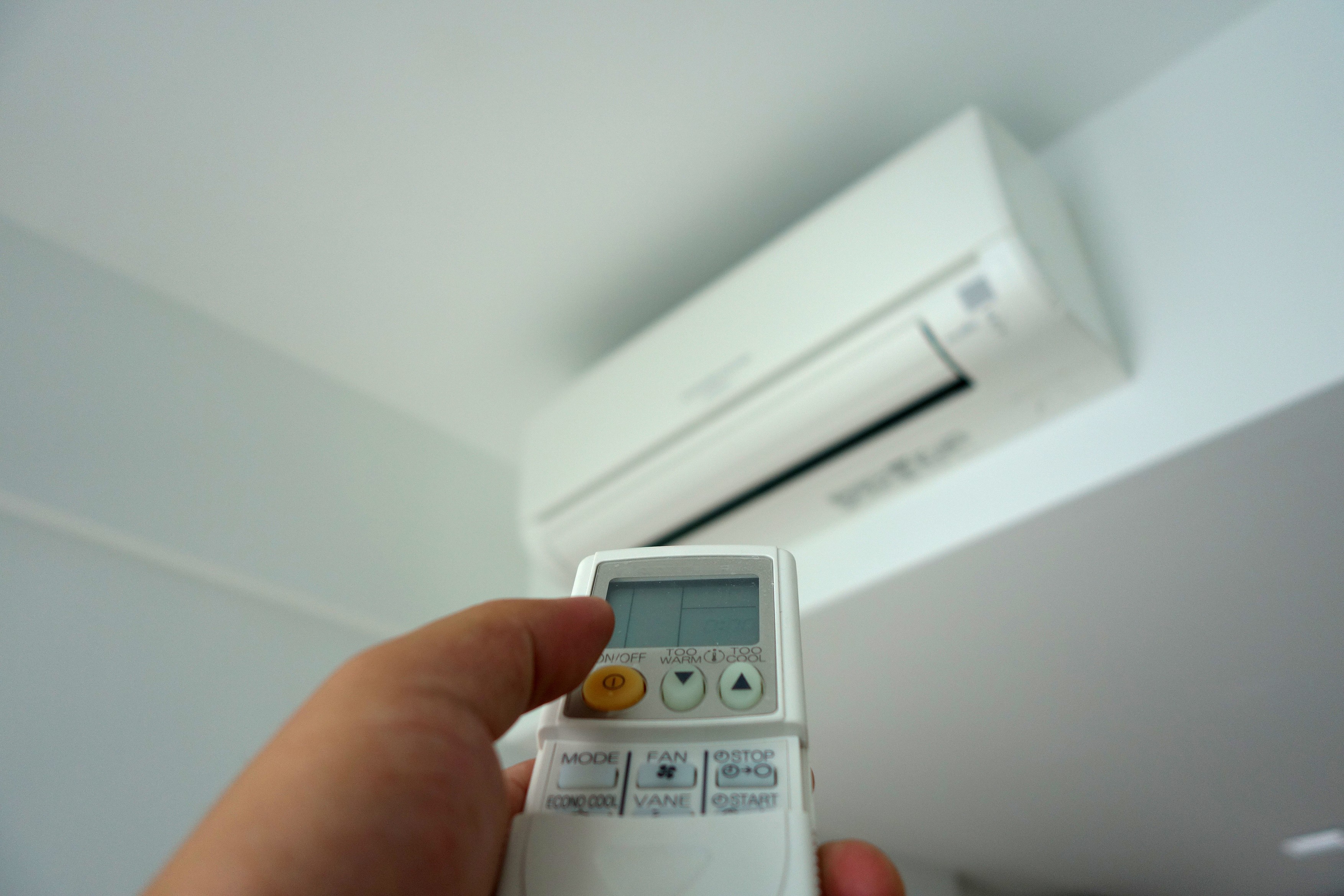 Hand holding remote control,  turning on of air conditioning,Image: 360386498, License: Royalty-free, Restrictions: , Model Release: no, Credit line: Yann Song Tang / Panthermedia / Profimedia