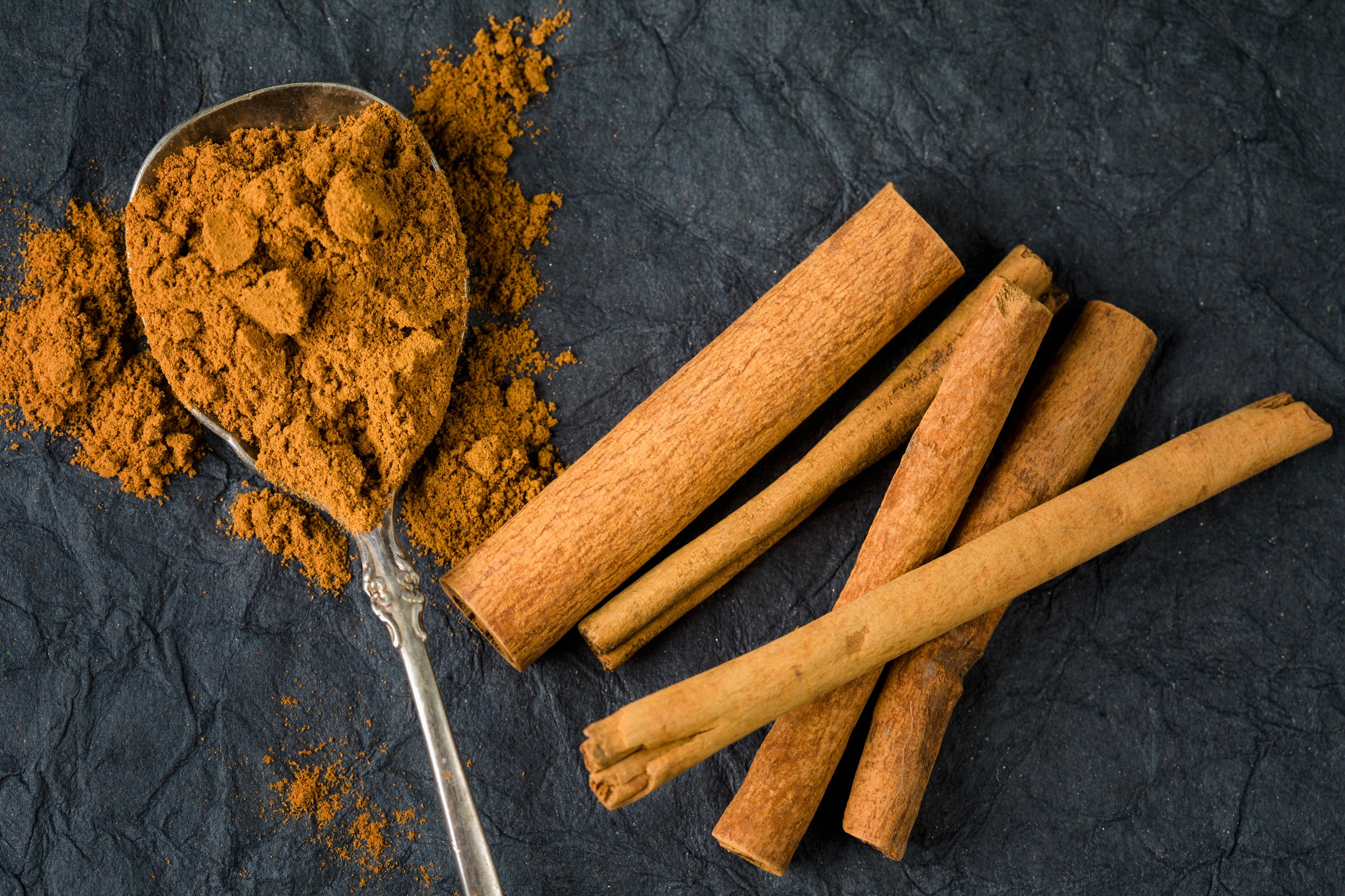 Overhead view of ground cinnamon and cinnamon sticks