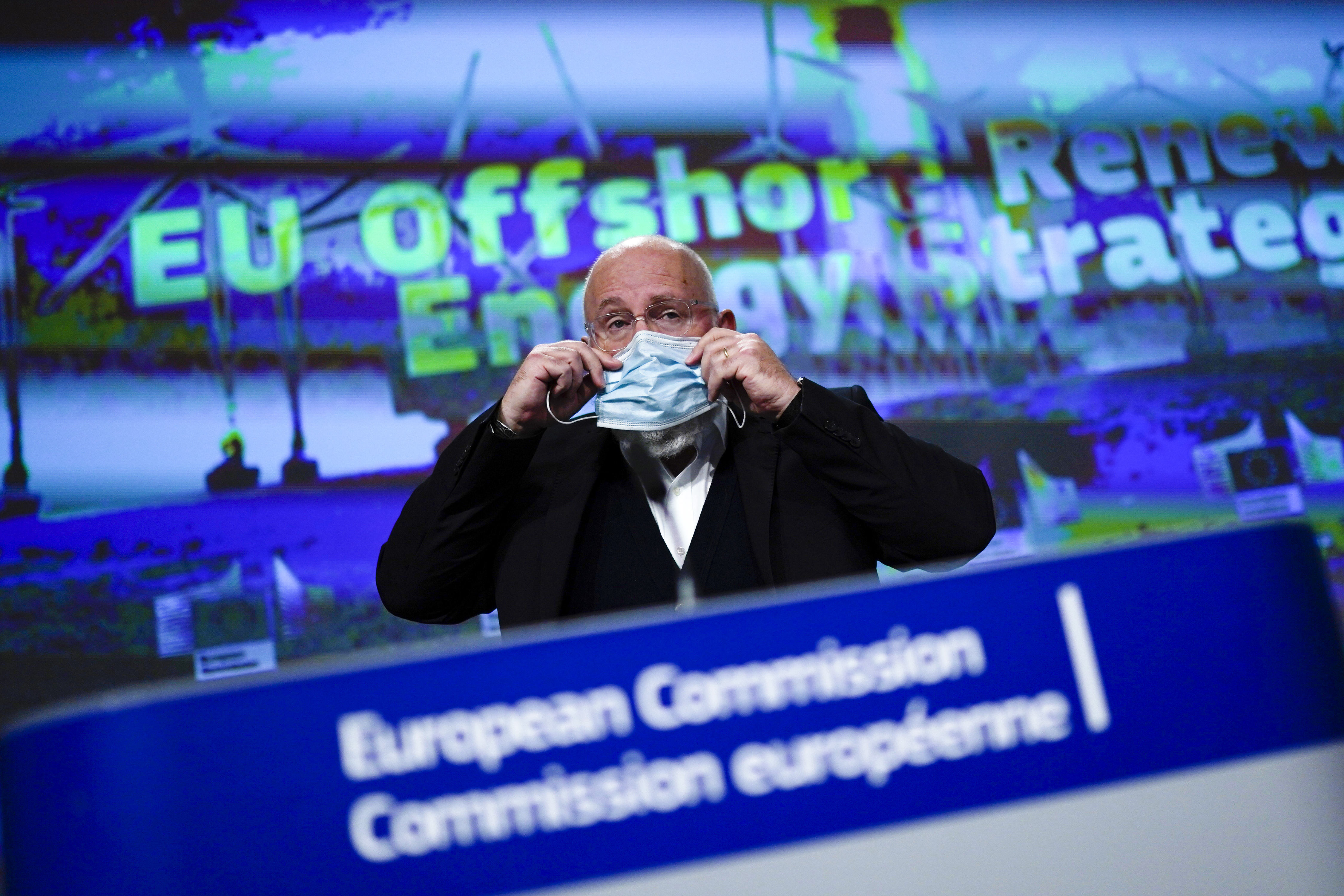 epa08829039 European Commissioner for European Green Deal Frans Timmermans adjusts his face mask during an online news conference on renewable energy at the EU headquarters in Brussels, Belgium, 19 November 2020.  EPA-EFE/FRANCISCO SECO / POOL