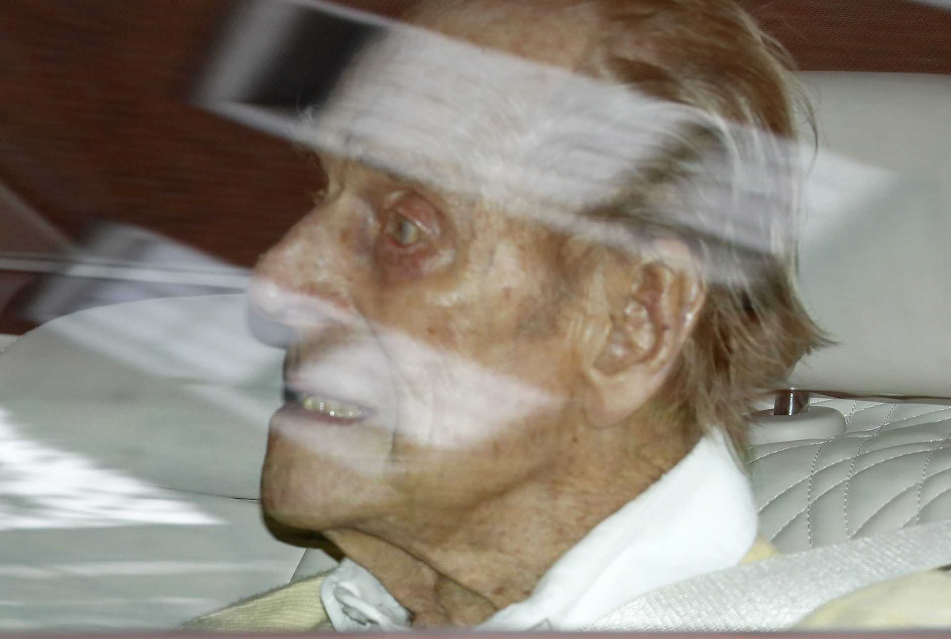 Britain's Prince Philip leaves the King Edward VII hospital in the back of a car in London, Tuesday, March 16, 2021. The 99-year-old husband of Queen Elizabeth II has been hospitalized after a heart procedure. (AP Photo/Alastair Grant)