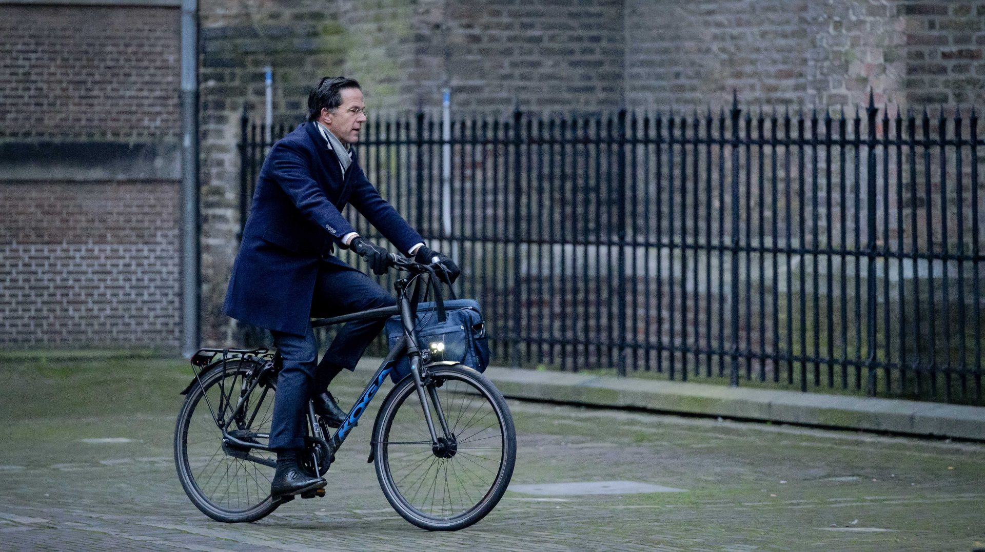 epa08950802 Dutch resigning Prime Minister Mark Rutte arrives by bike for the consultations of the Ministerial Committee COVID-19 (MCC) on the ongoing coronavirus pandemic. Among other things, the measure of a curfew is being discussed.  EPA-EFE/BART MAAT