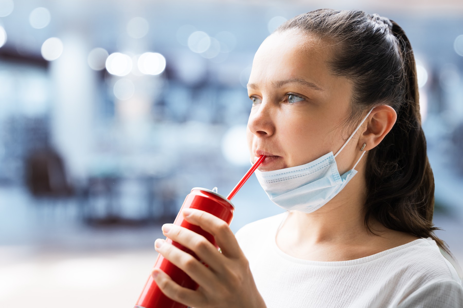 Woman Drinking Soda In Face Mask At Outside,Image: 518471769, License: Royalty-free, Restrictions: , Model Release: yes, Credit line: Andriy Popov / Panthermedia / Profimedia