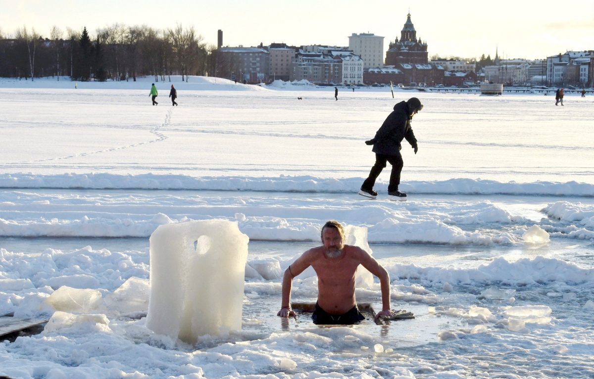 A winter swimmer takes a dip into water through sea ice in Helsinki, Finland on February 14, 2021.,Image: 590969521, License: Rights-managed, Restrictions: Finland OUT, Model Release: no, Credit line: Jussi Nukari / AFP / Profimedia