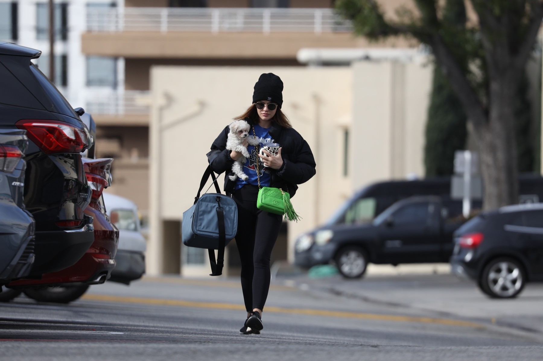 *EXCLUSIVE* Lucy Hale carries her green Chanel tote and a gym bag while arriving at the gym with her new adopted pup