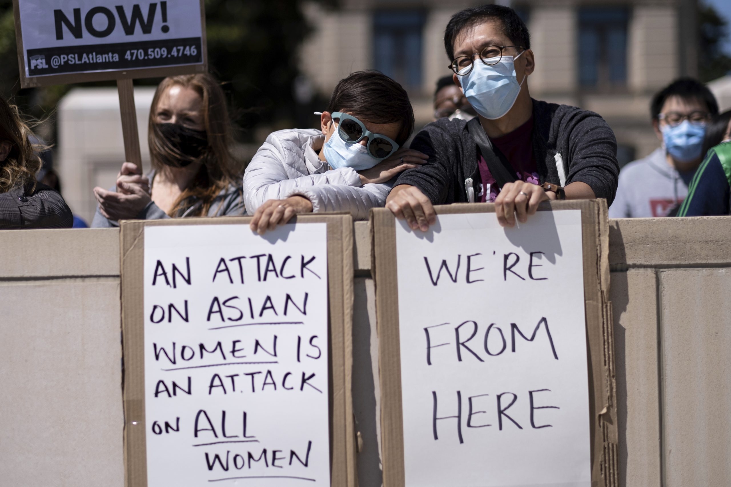 Agata Rozga leans her head on Rich Vuduc's arm as they participate in a "stop Asian hate" rally outside the Georgia State Capitol in Atlanta on Saturday afternoon, March 20, 2021. (AP Photo/Ben Gray)