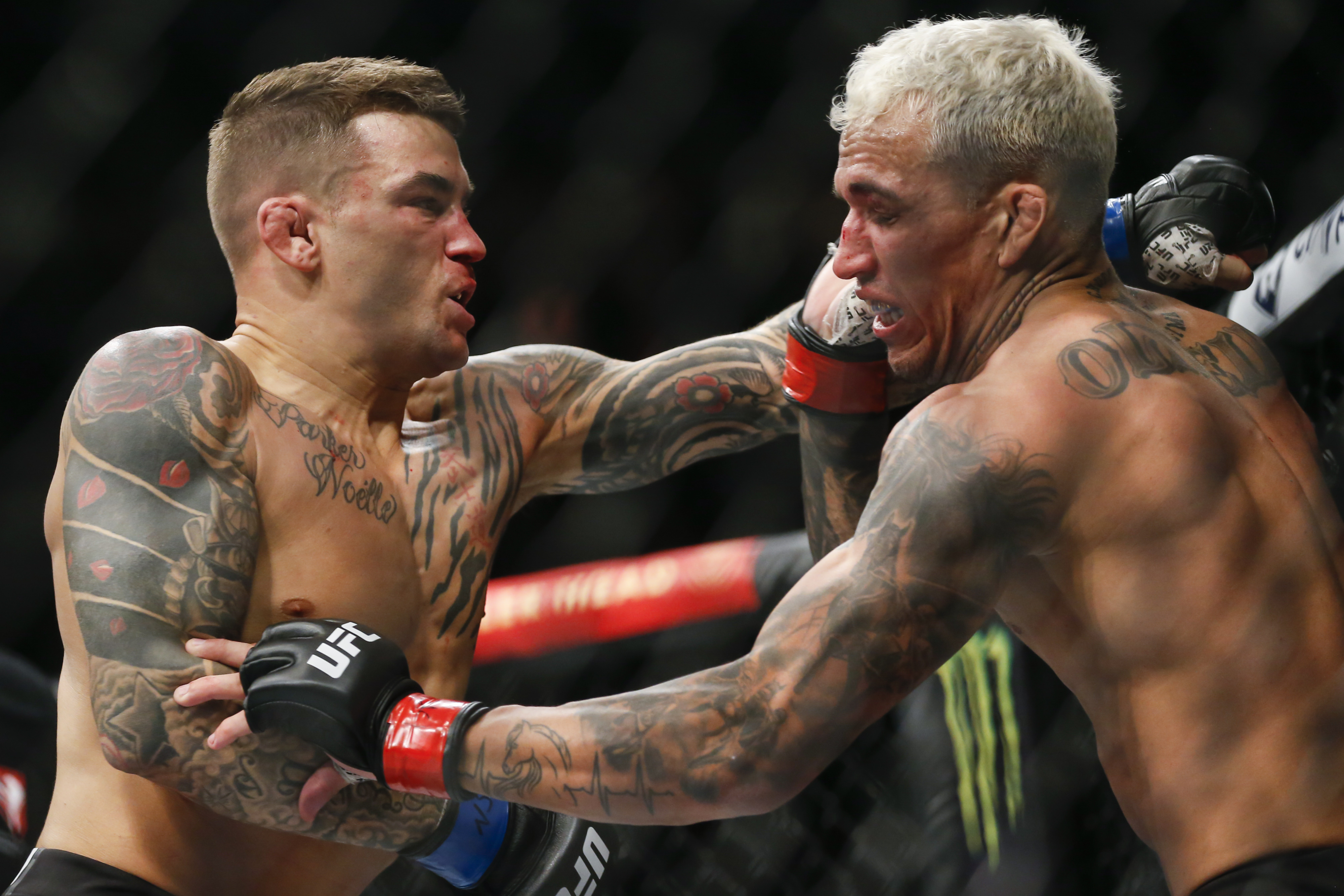 Dustin Poirier, left, fights Charles Oliveira during a lightweight mixed martial arts title bout at UFC 269, Saturday, Dec. 11, 2021, in Las Vegas. (AP Photo/Chase Stevens)